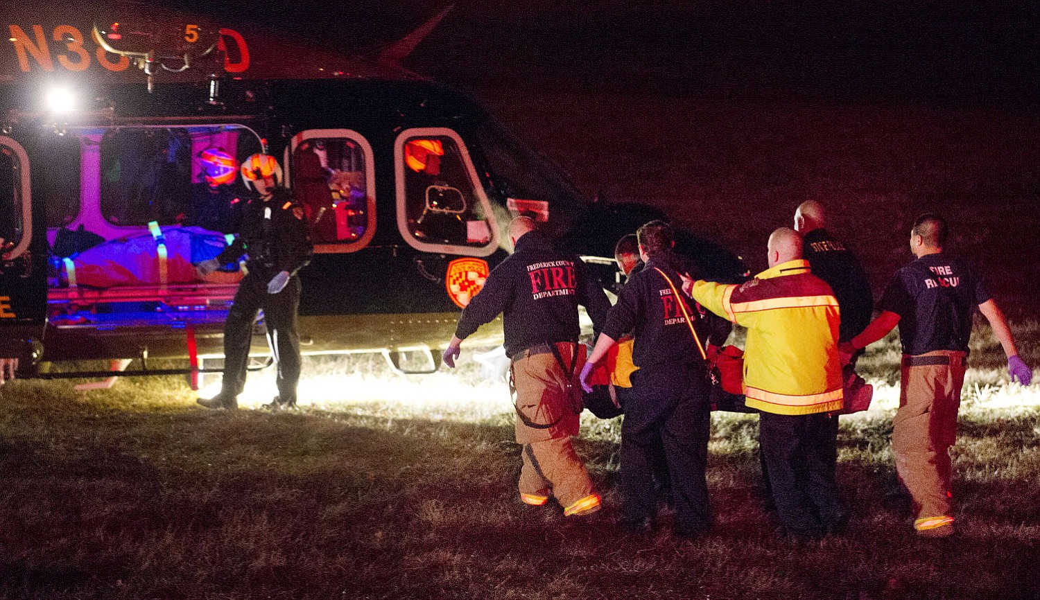A patient is brought to a helicopter Wednesday following a shooting outside Frederick High School in Frederick, Md.