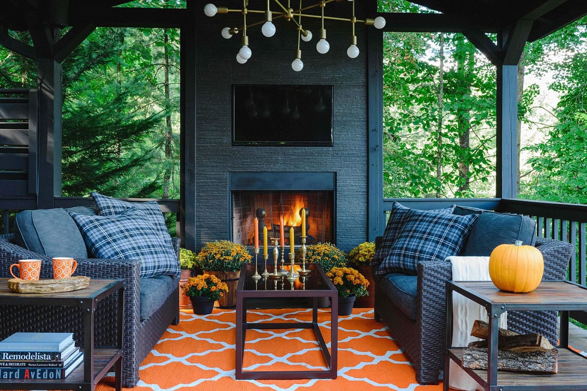 Brian Patrick Flynn/Hayneedle
To take advantage of the gorgeous autumn weather at his mountain house, designer Brian Patrick Flynn added a modern fireplace. To enhance fall style, Flynn changes up throw pillows in October by swapping pillow cases sporting summer tones with those more suited for autumn.