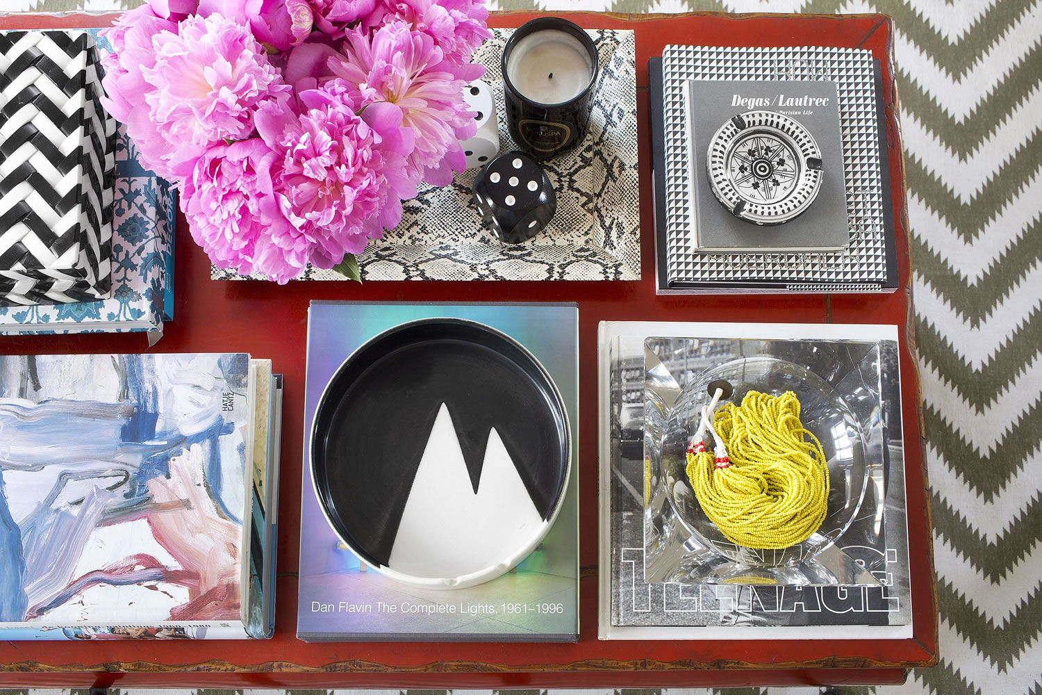 In this photo provided by Burnham Design, homeowners who love having lots of items on hand but don?t want their coffee table to look cluttered can take inspiration from this tabletop designed by Max Humphrey of Burnham Design in Los Angeles. Humphrey uses decorative trays to corral items and bring a sense of organization to this very full, colorful table.