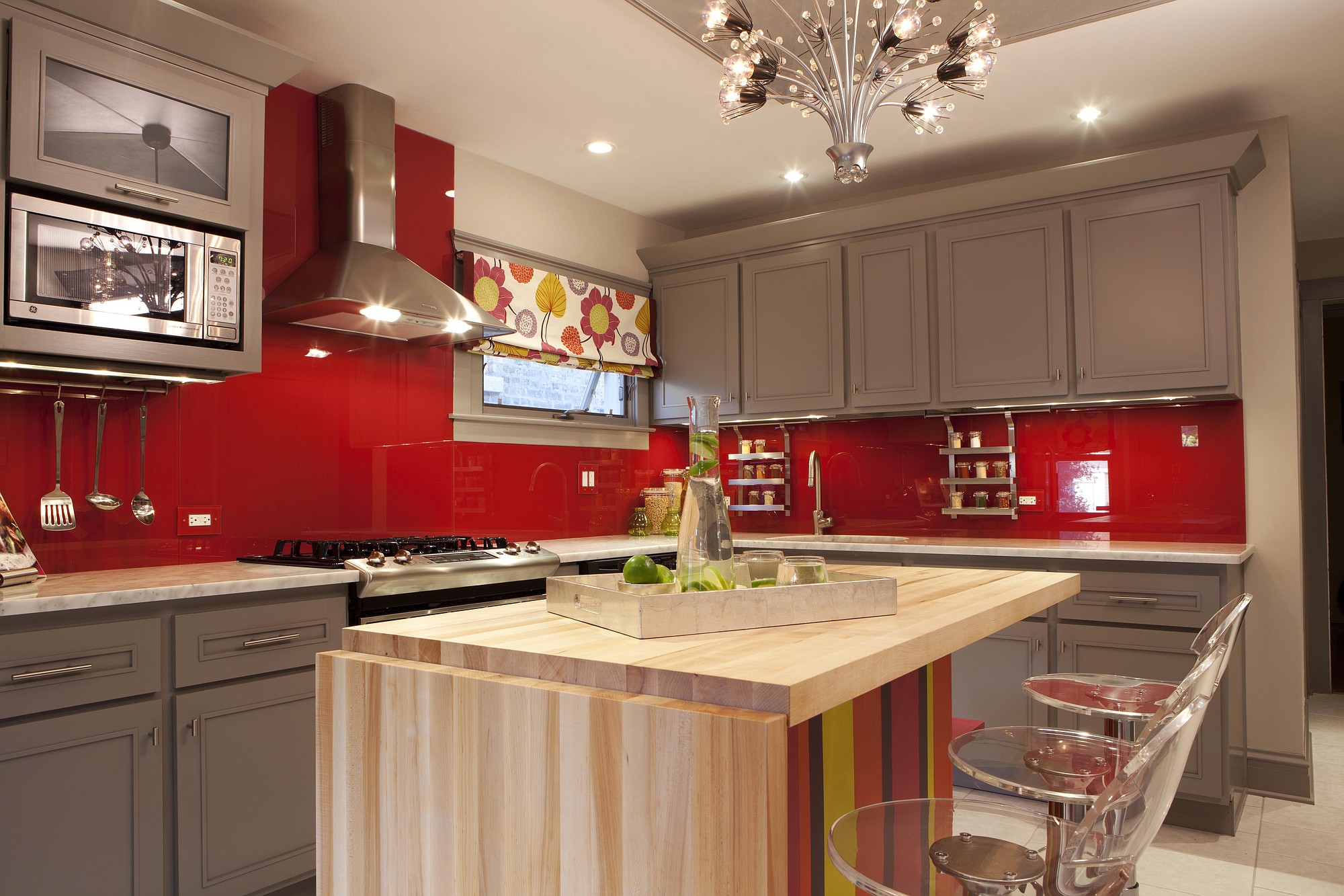 Designer and host of HGTV's Great Rooms, Meg Caswell, painted the walls red then added a clear glass cover to create a chic, vibrant backsplash.