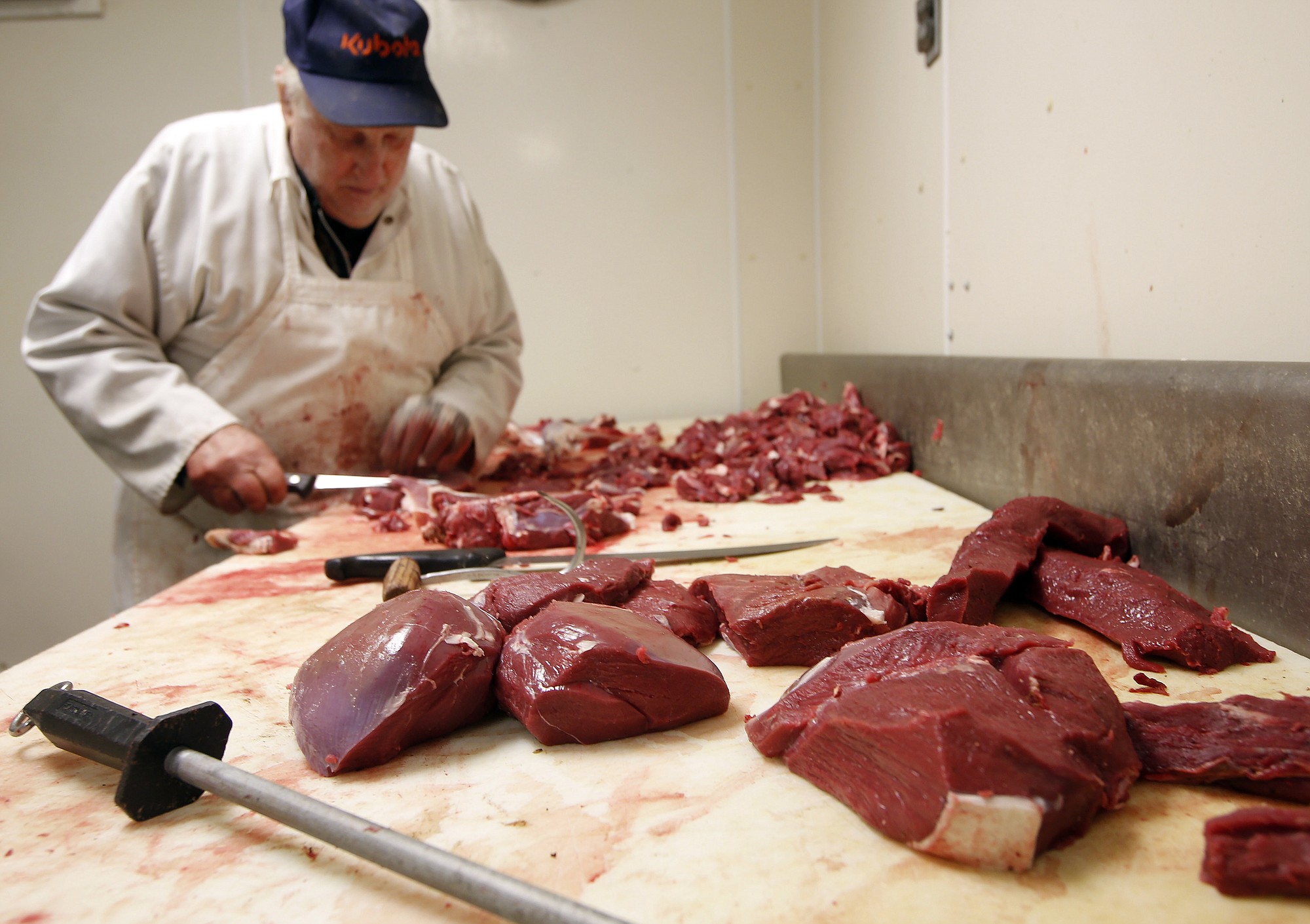 Veteran meat-cutter Everett Gage cuts steaks and roasts from deer Monday following the first weekend of the deer rifle season in Loudon, N.H.