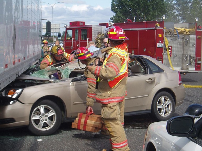 A collision between a Chevy Malibu and a semi-truck trailer caused backups on Highway 14 and Interstate 5.