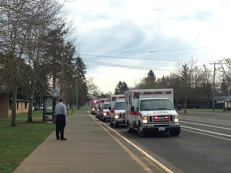 Ambulances line up outside of McLoughlin Middle School in Vancouver late Wednesday morning after a number of students fell ill after apparently ingesting chilli powder.