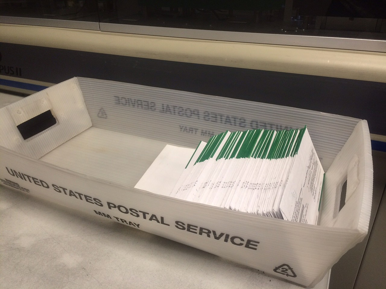 A United States Postal Service tray contains some of the hundreds of ballots received in the mail Friday by Clark County elections officials.
