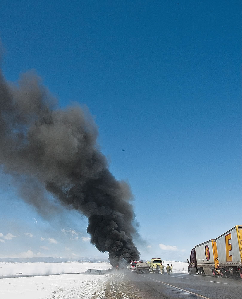 Smoke rises as emergency personnel respond to a a fiery chain-reaction crash on Interstate 80 near Laramie, Wyo., on Monday.