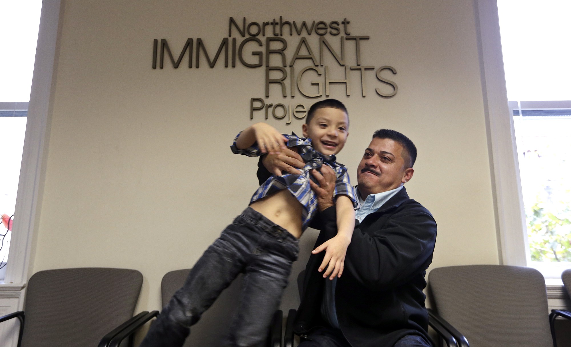 Ignacio Lanuza-Torres playfully lifts his son, Isaiah, 4, as he has his photo taken Oct. 17 in Seattle. A U.S.