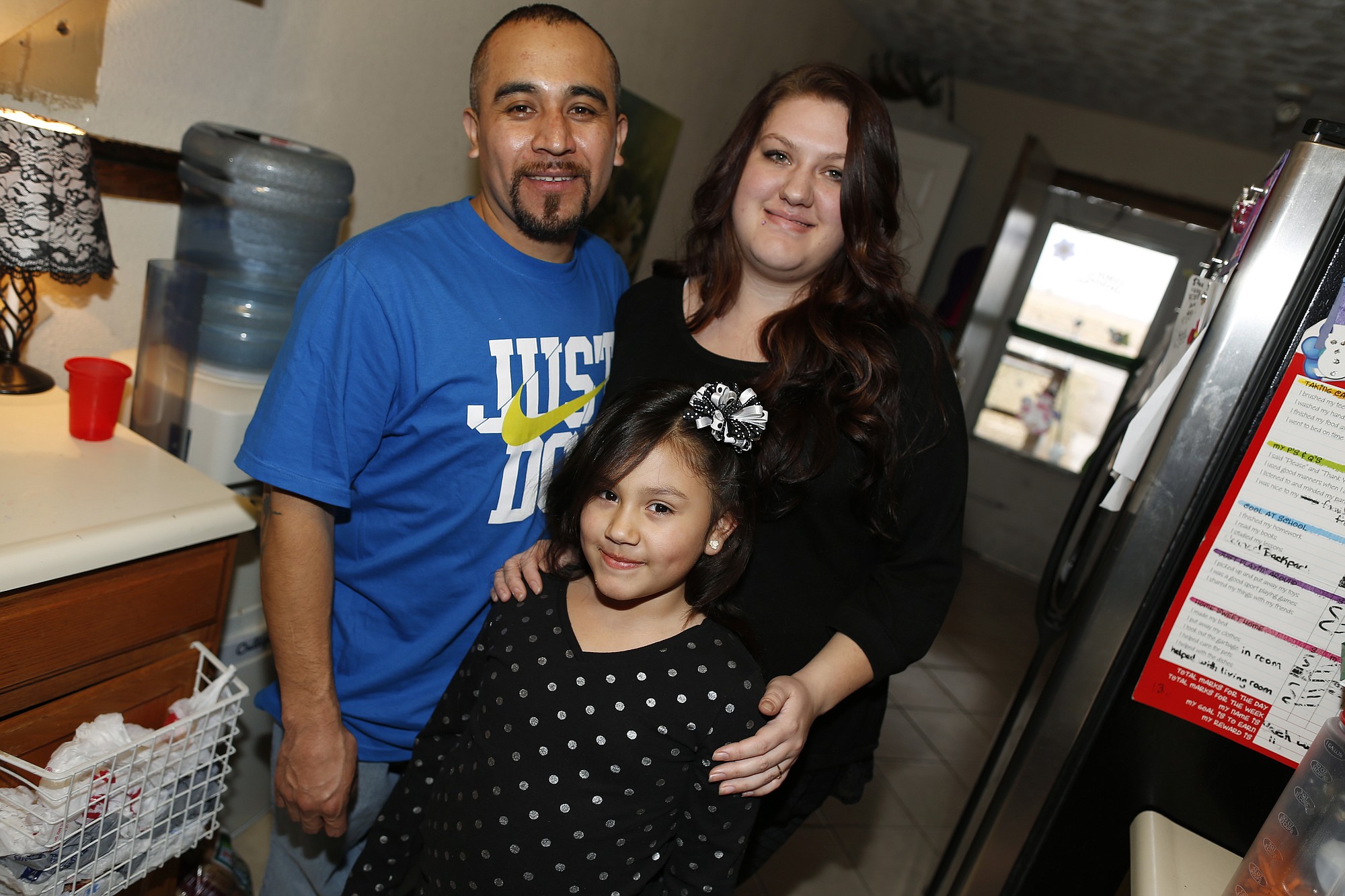 Maximiano Vazquez-Guevara, left, his wife Ashley Bowen, and their 6-year-old daughter, Nevaeh Vazquez, pose for a photo in their home Saturday in the northeast Denver suburb of Commerce City, Colo. The presidential executive order that fast-tracked immigration hearings for last summer's flood of Central American migrants may have had unintended consequences in canceling hearings for non-detained immigrants with longstanding cases such as Vazquez-Guevara. Vazquez-Guevarra, 34, recently won his appeal to become a legal permanent resident.