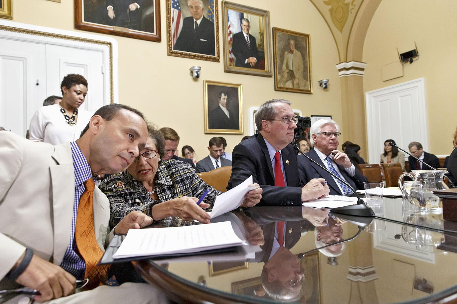 Rep. Luis V. Gutierrez, D-Ill., from left, confers with Rep. Nita Lowey, D-N.Y., , as the House Rules Committee meets Friday in Washington to deal with the influx of migrant children at the U.S.-Mexico border. They are joined by House Judiciary Committee Chairman Rep. Bob Goodlatte, R-Va., and Rep.
