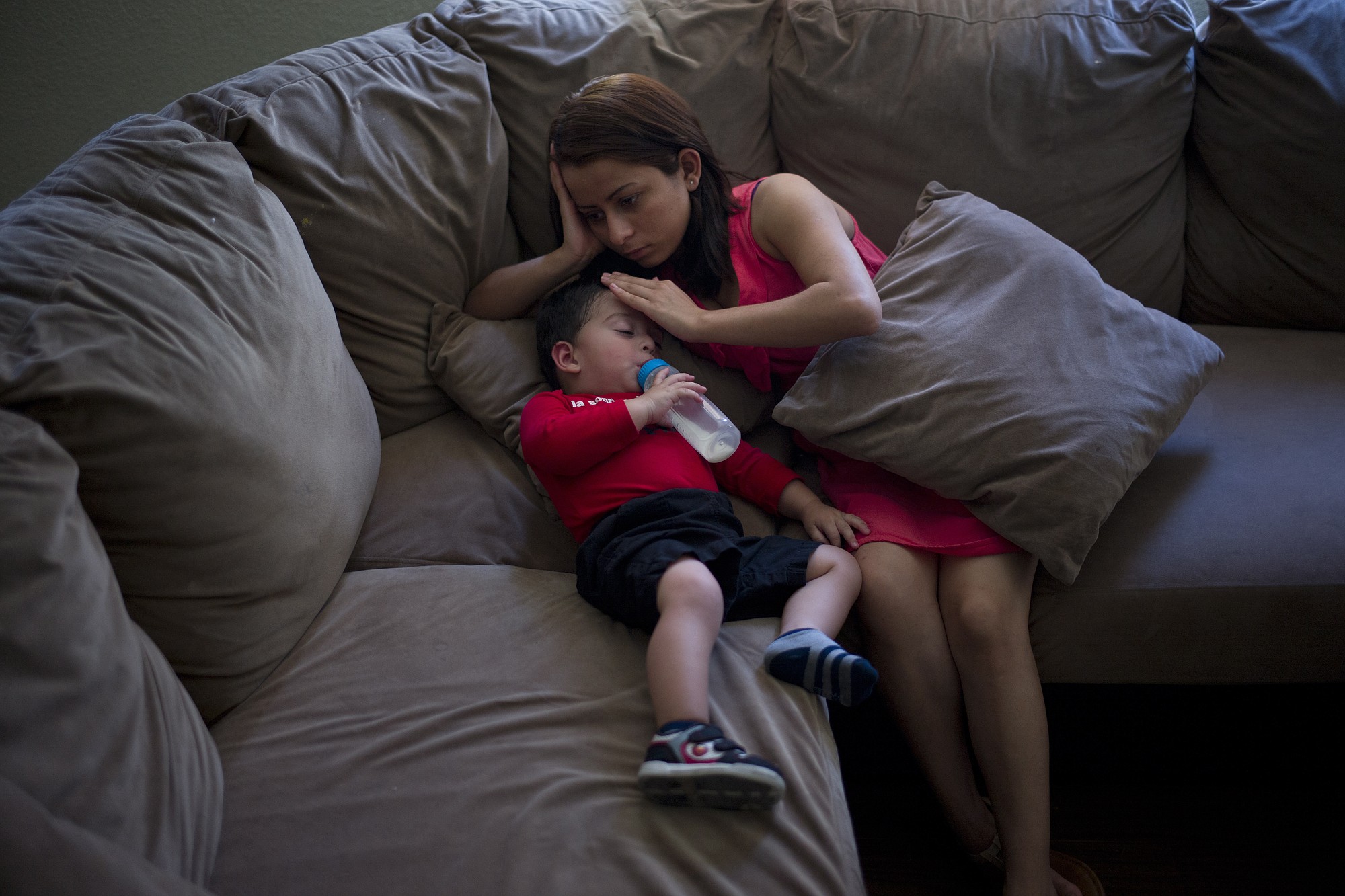 Joshua Tinoco, 1, snuggles with his mother, Dunia Bueso, 18, at a relative's home in Los Angeles. At a brief hearing, a government lawyer told the teenage mother that her son is an immigration enforcement priority for the U.S.