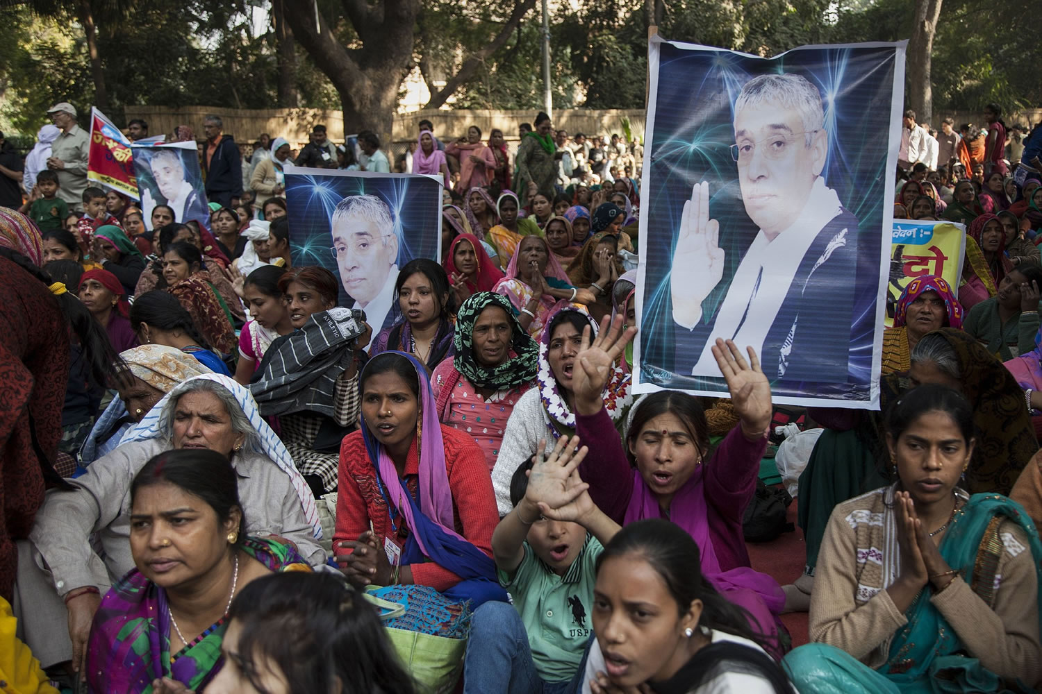 Supporters of controversial Indian guru Sant Rampal displaying his photographs, chant slogans praising him as they gather to show support at a protest venue near the Indian Parliament in New Delhi, India, on Tuesday.