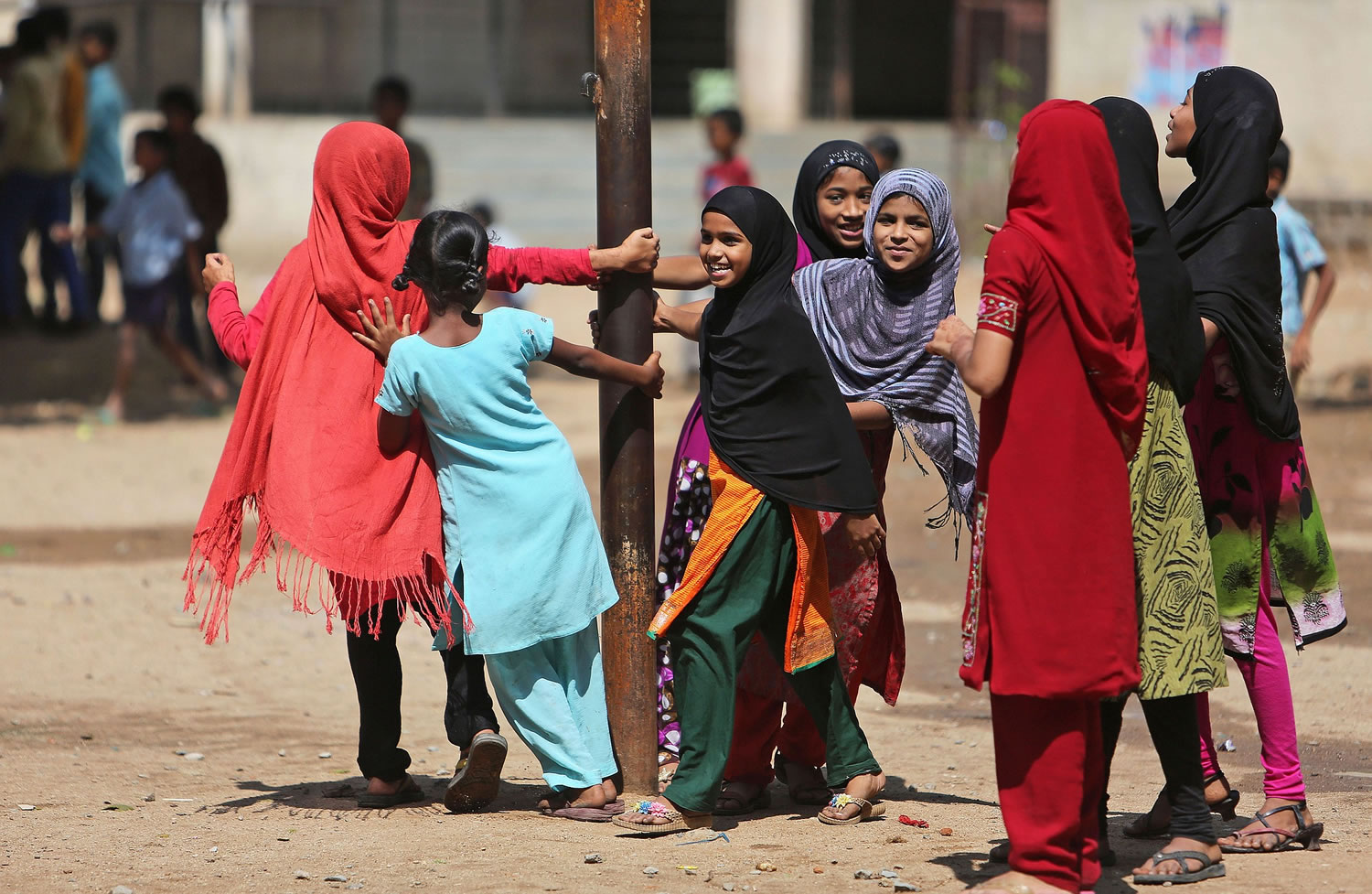 Schoolgirls play at a government school Tuesday in Hyderabad, India.