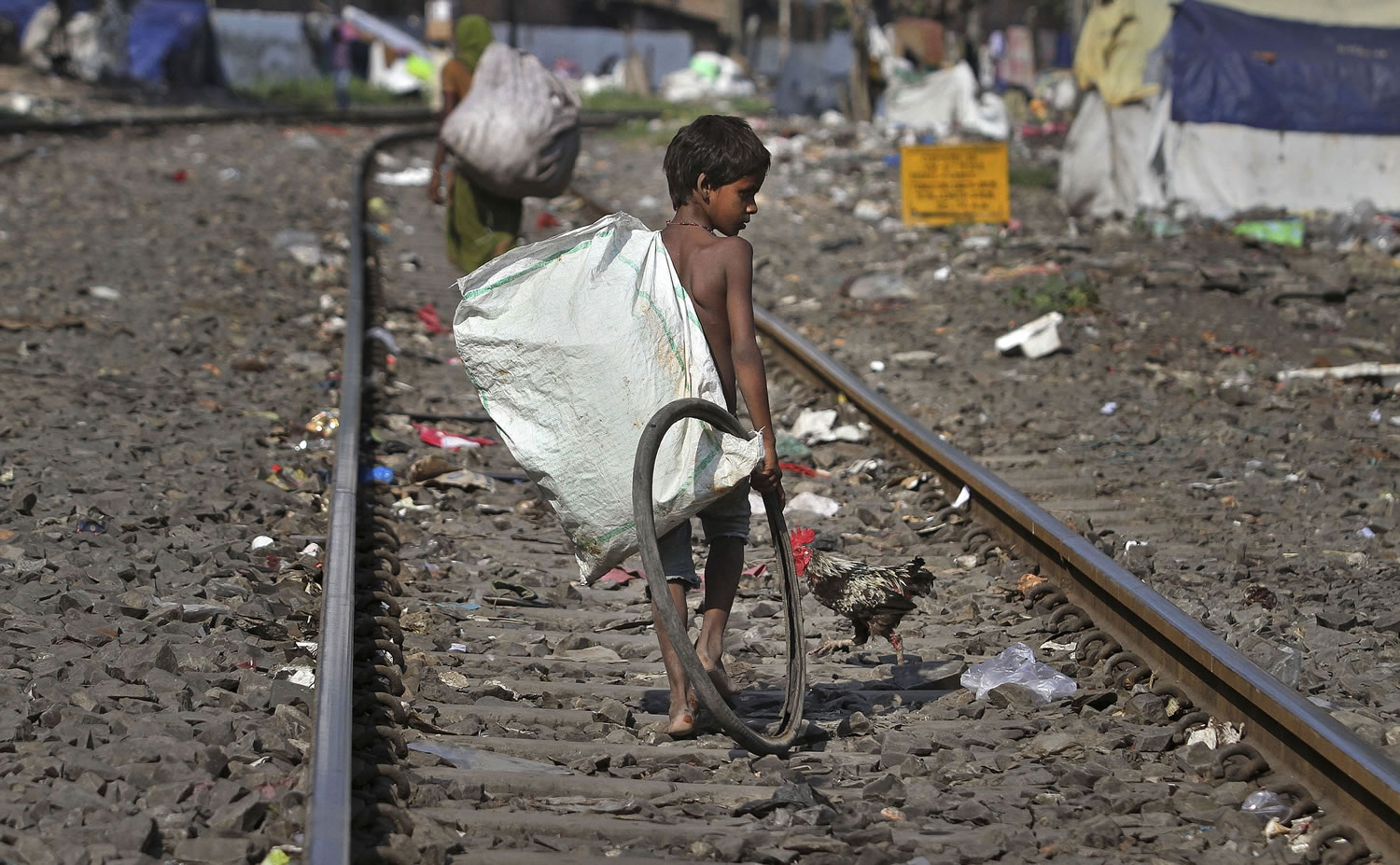 An Indian ragpicker searches Friday for reusable materials from garbage thrown on railway tracks in Gauhati, India.