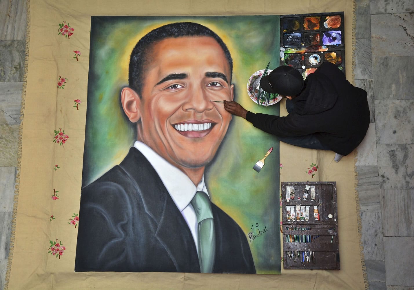 Indian artist Jagjot Singh Rubal puts final touches on a painting of U.S. President Barack Obama on Friday in Amritsar, India. Obama arrives in New Delhi on Sunday and will be the first American president to attend India's annual Republic Day festivities, celebrated annually on Jan.