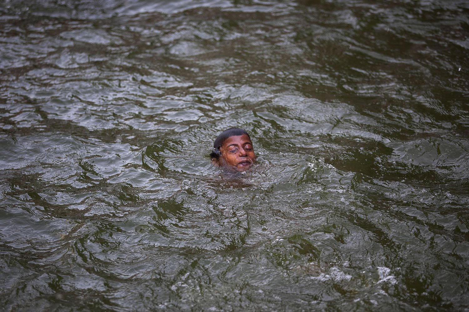 An Indian boy swims in a water body on a hot summer day in New Delhi, India, Tuesday, May 26, 2015. Delhi recorded a maximum temperature of 46 degrees Celsius on Tuesday. In southern India, more than 750 people have died since the middle of April as soaring summer temperatures scorch the country, officials said Tuesday.