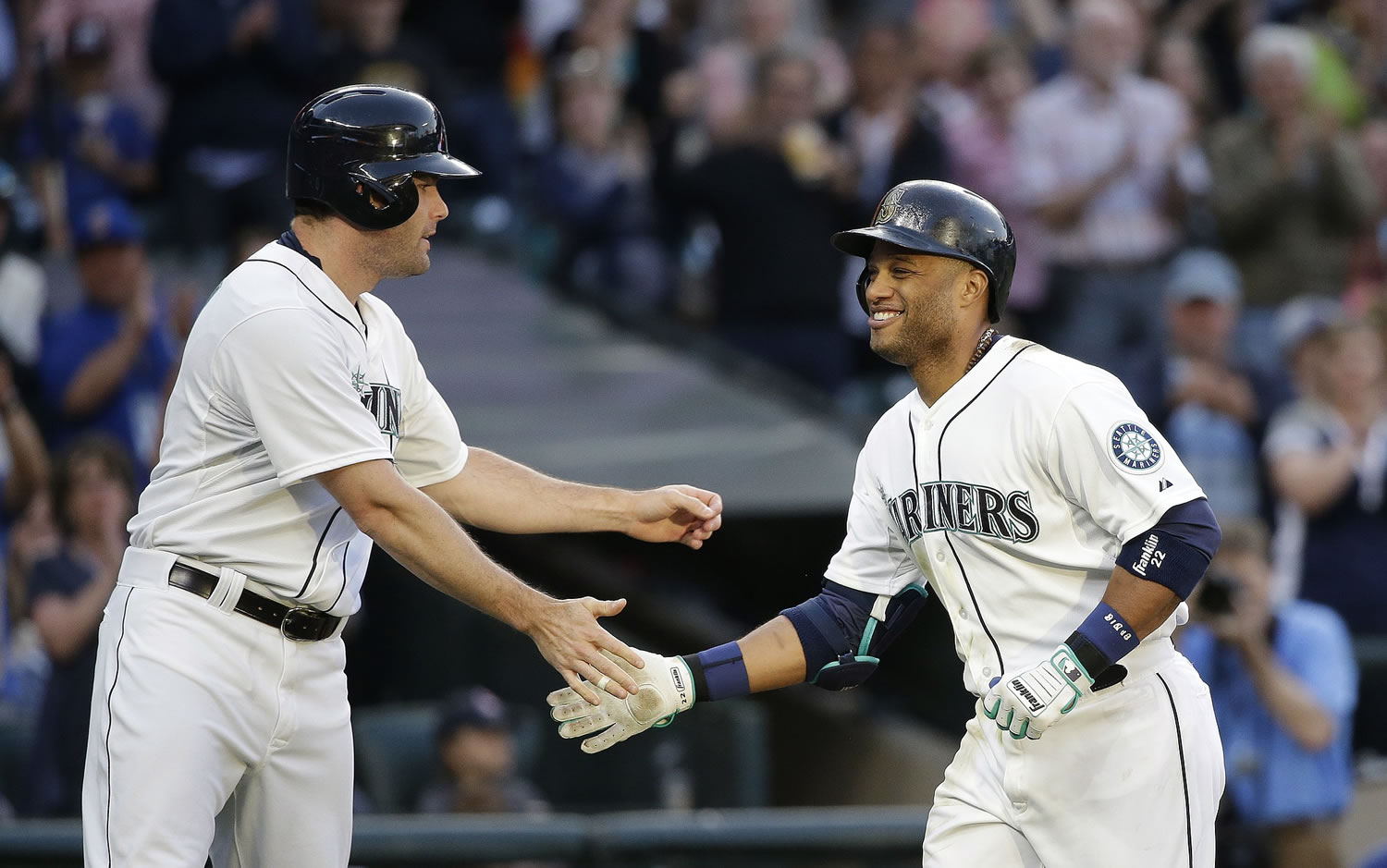 Seattle Mariners' Robinson Cano, right, is congratulated by Seth Smith after Cano's home run in the third inning Saturday, May 30, 2015, in Seattle.