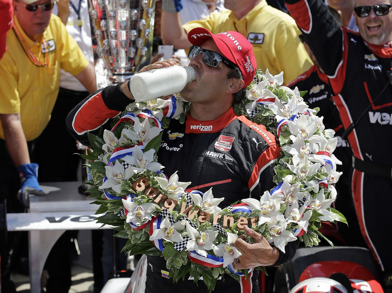 Juan Pablo Montoya celebrates with the traditional swig of milk after winning the 99th running of the Indianapolis 500 on Sunday, May 24, 2015.
