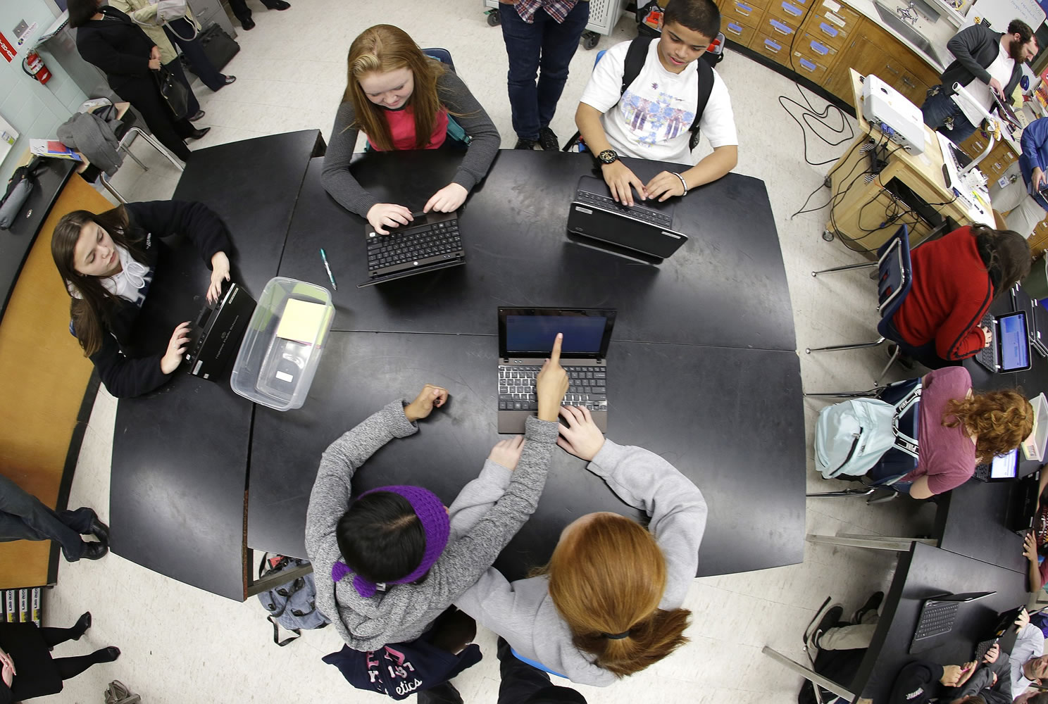 Students at Pacific Middle School in Des Moines work on laptop computers Dec. 9 as they take part in the international Hour of Code project.