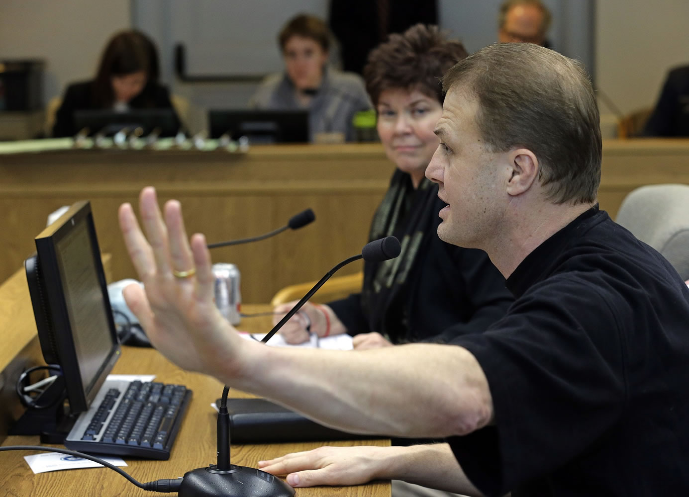 Initiative promoter Tim Eyman, right, speaks Monday before the Senate Ways and Means Committee in Olympia as Sen.