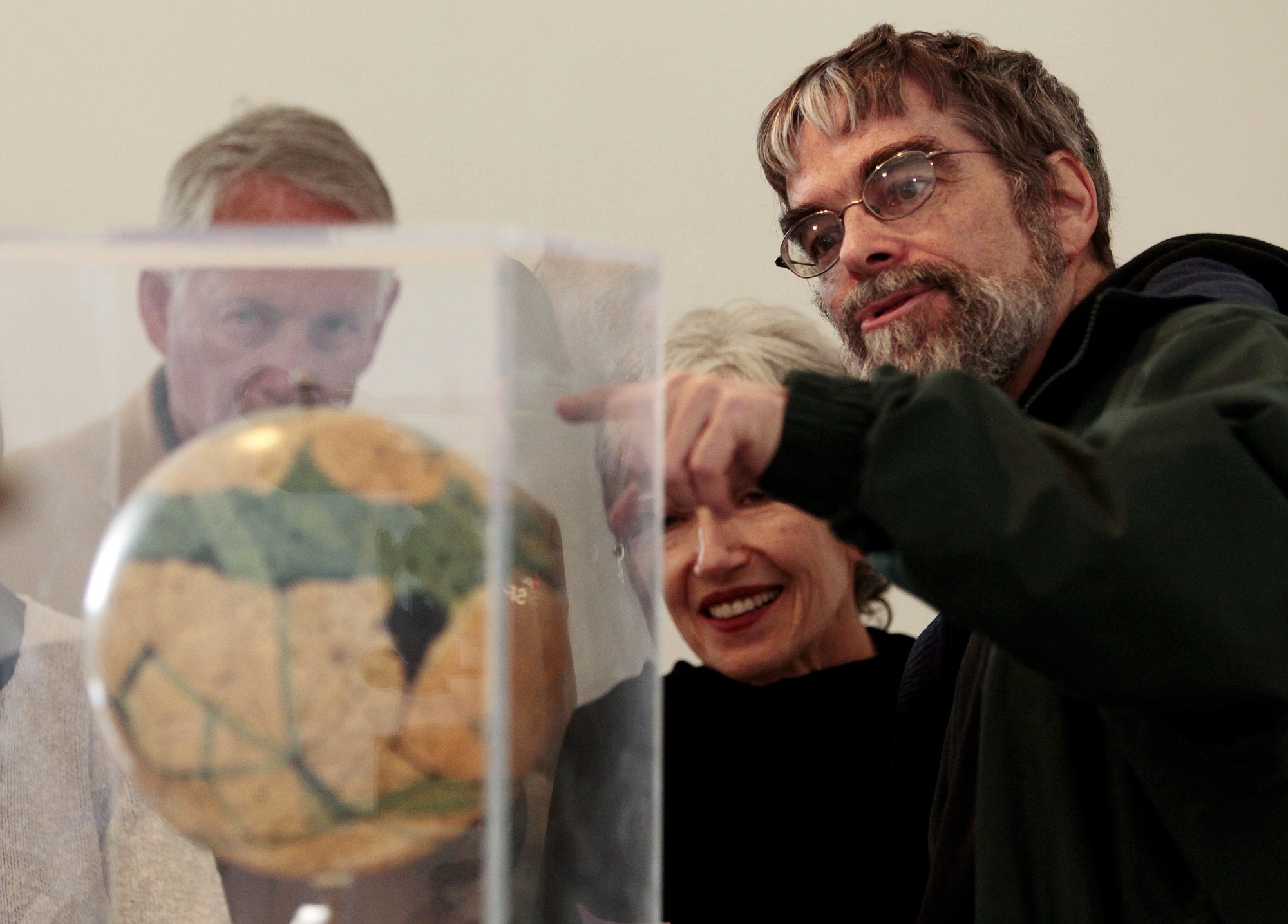 Associated Press files
Brother Guy Consolmagno, a Jesuit astronomer at the Vatican's Observatory, right, shows to visitors the Globe of planet Mars from the collection of the Specola Vaticana during an exhibition celebrating the 400th anniversary of demonstration of Galileo's telescope April 15 on the Gianicolo hill, at Rome's American Academy in Rome.