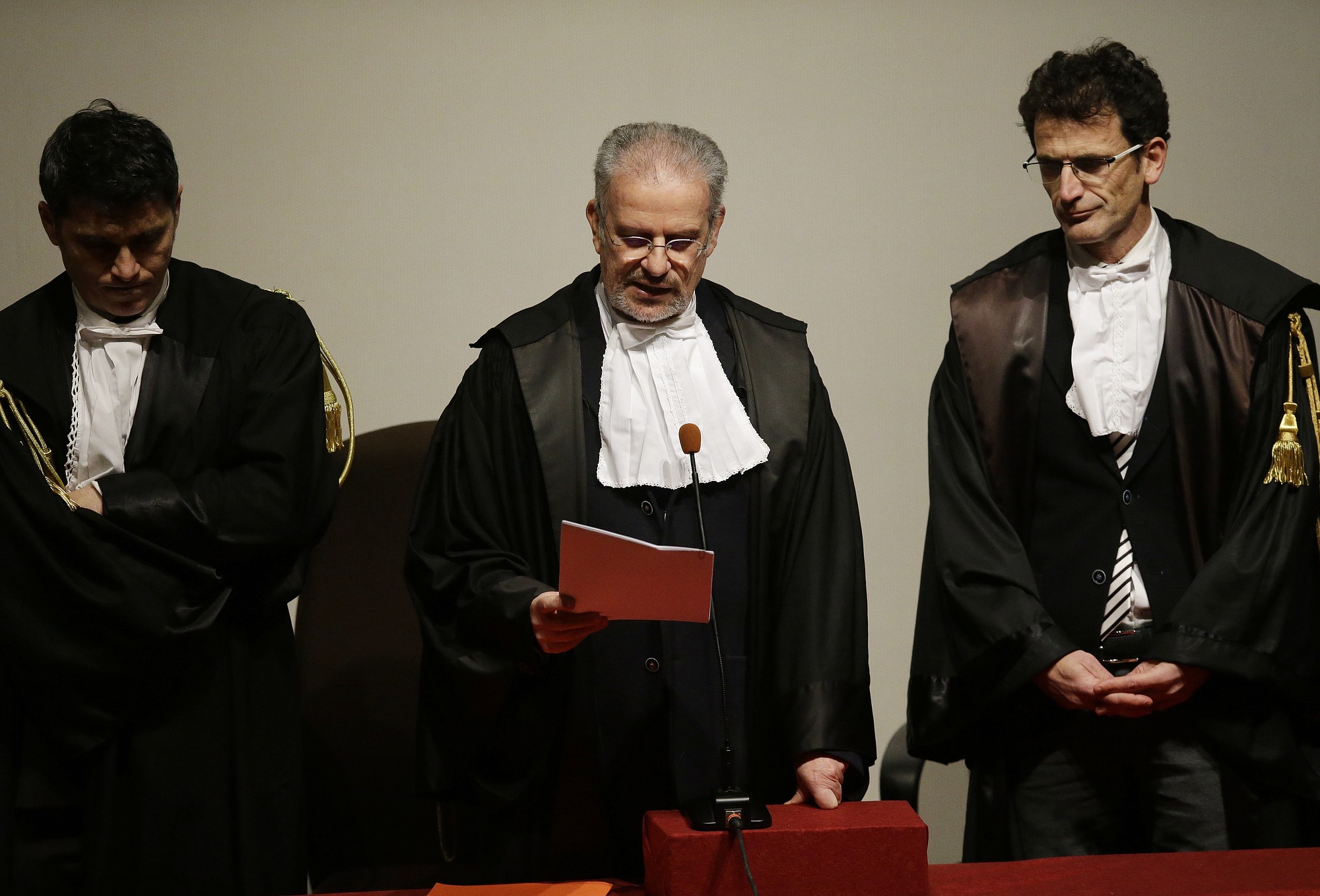 Judge Giovanni Pugliatti, center, reads the verdict Wednesday at the end of the trial for Costa Concordia captain Francesco Schettino at the Grosseto court, Italy.
