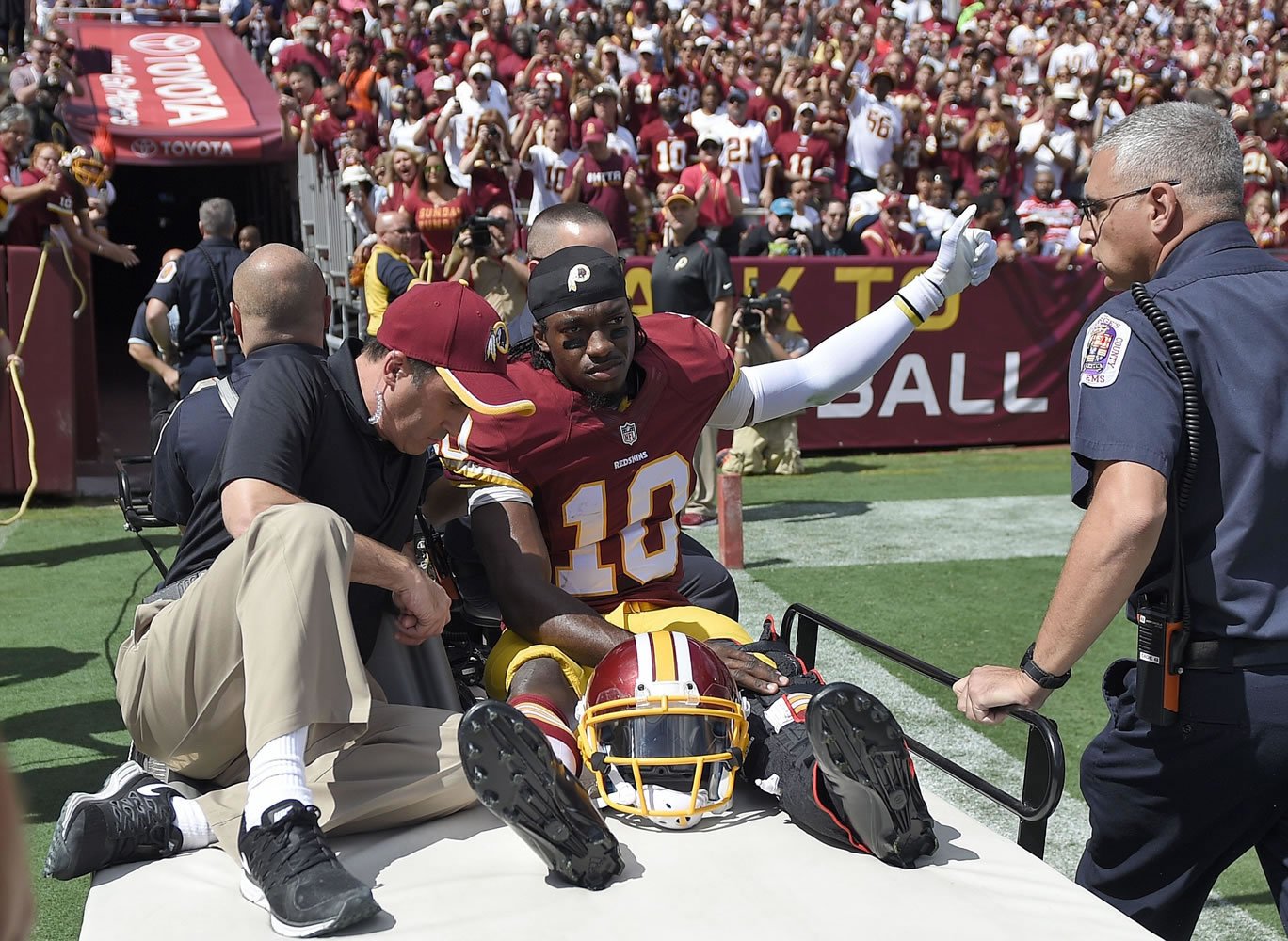 Washington Redskins quarterback Robert Griffin III (10) leaves the game on a cart after injuring his left ankle during the first half against the Jacksonville Jaguars on Sunday, Sept. 14, 2014, in Landover, Md.