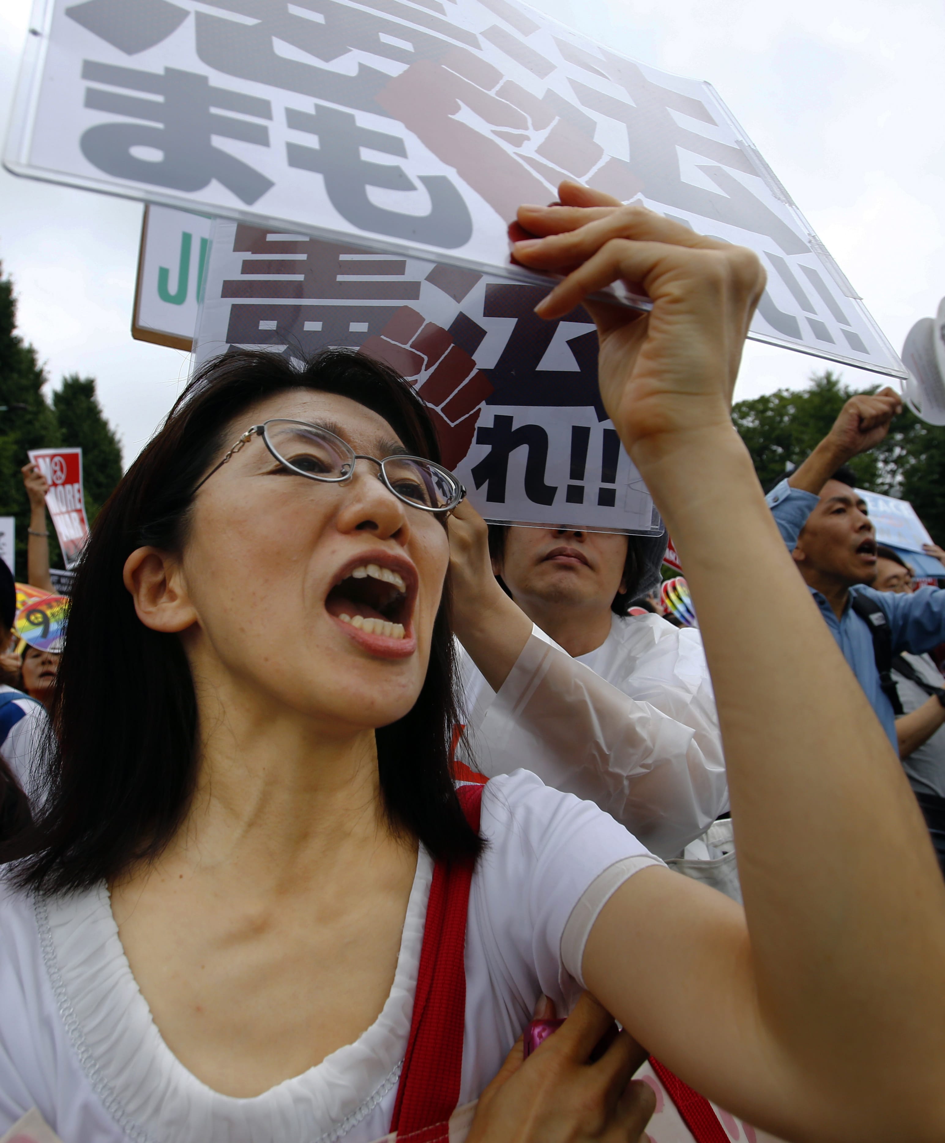 A protester shouts slogans during a rally in front of the National Diet building in Tokyo, Sunday, Aug. 30, 2015. Thousands of Japanese protested outside the parliament a set of security bills designed to expand the role the country's military. The bills - a cornerstone of Prime Minister's Shinzo Abe's move to shore up Japan's defenses in the face of growing threats in the region - are expected to pass next month despite criticism they undermine Japan&iacute;s post-war pacifism.