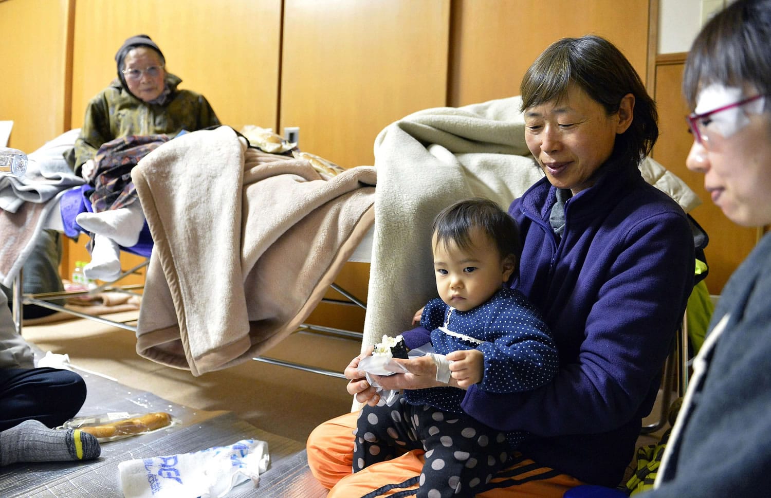 Evacuees have breakfast after spending a night at a shelter Sunday after a strong earthquake hit Hakuba, Nagano prefecture, central Japan, Saturday night.