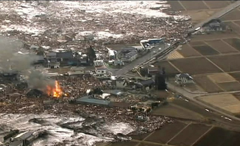 In this image made off Japan's NHK TV video footage, houses are washed away by tsunami in Sendai, Miyagi Prefecture (state) eastern Japan, after Japan was struck by a magnitude 8.9 earthquake off its northeastern coast Friday, March 11, 2011.