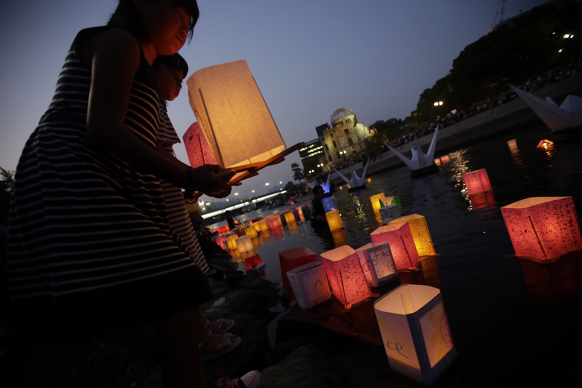 Children release paper lanterns Thursday on the Motoyasu River in Hiroshima, Japan,  where thousands of atomic bomb victims died.