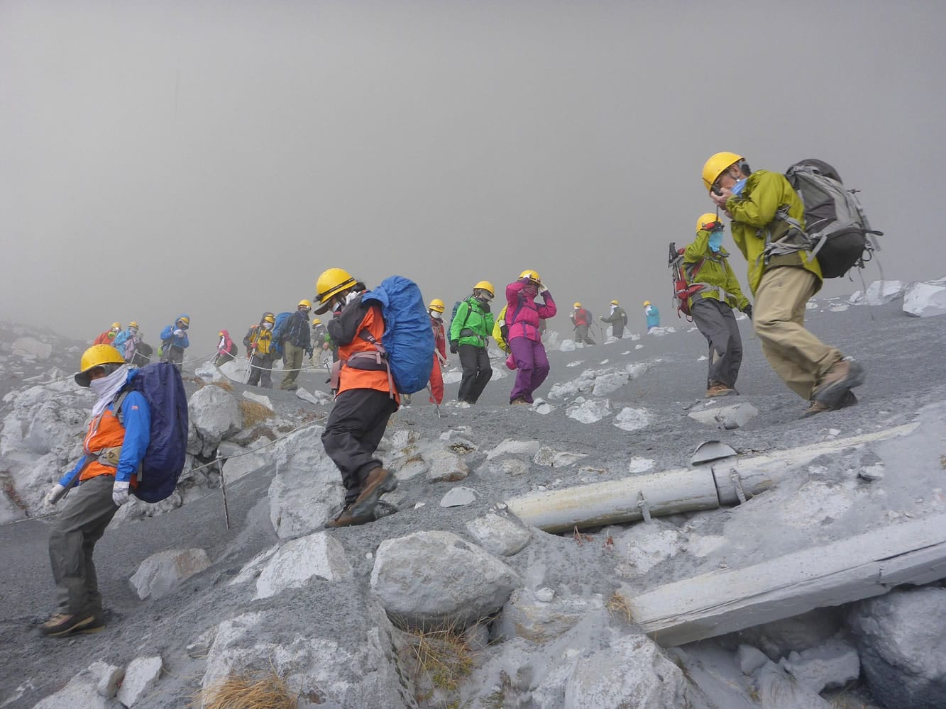In this photo taken by an anonymous climber and offered to Kyodo News, climbers descend Mt. Ontake to flee as the volcanic mountain erupts in central Japan, Saturday, Sept. 27, 2014.