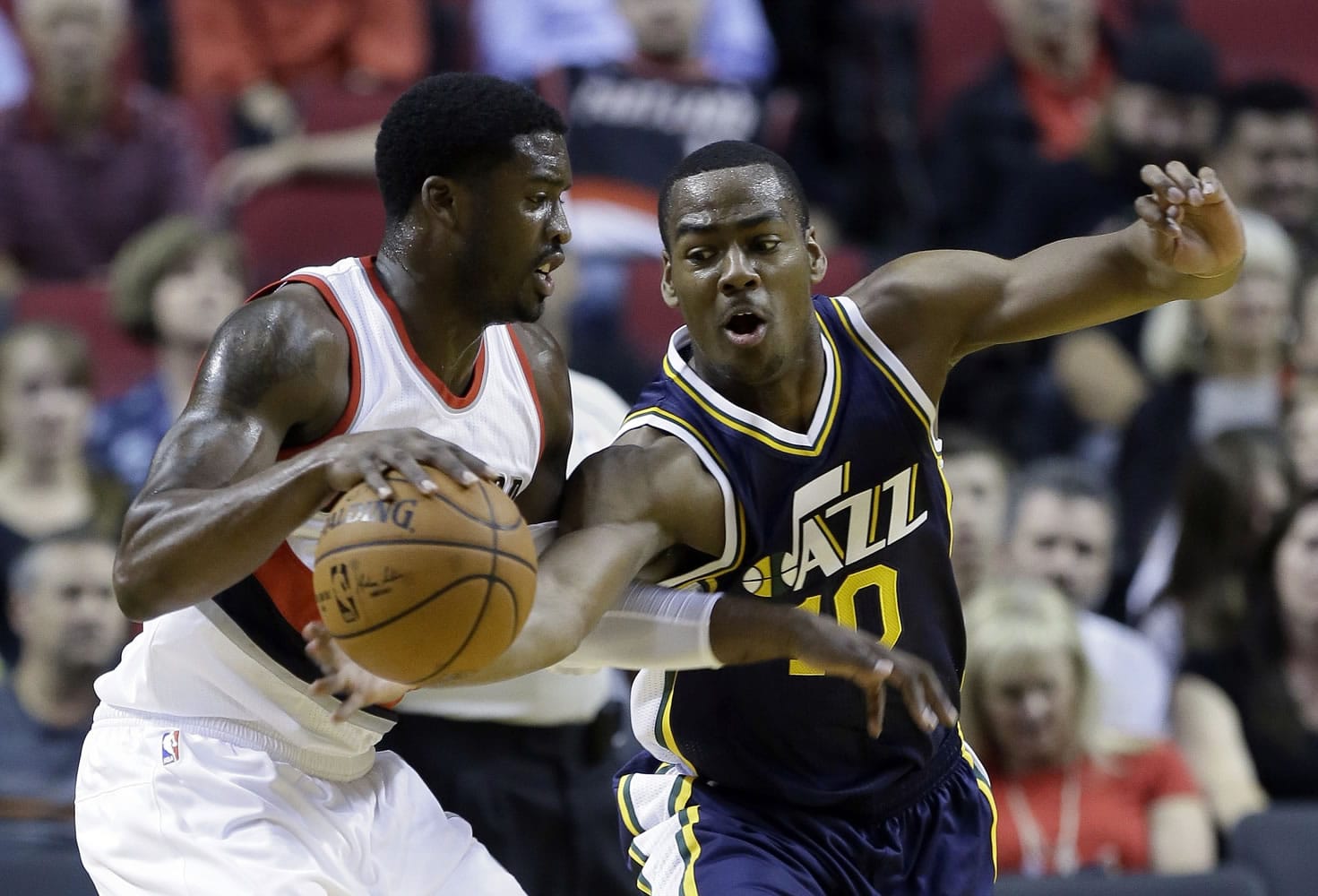Utah Jazz guard Alec Burks, right, reaches in on Portland Trail Blazers guard Wesley Matthews during the first half of a pre-season NBA basketball game in Portland, Ore., Thursday, Oct.