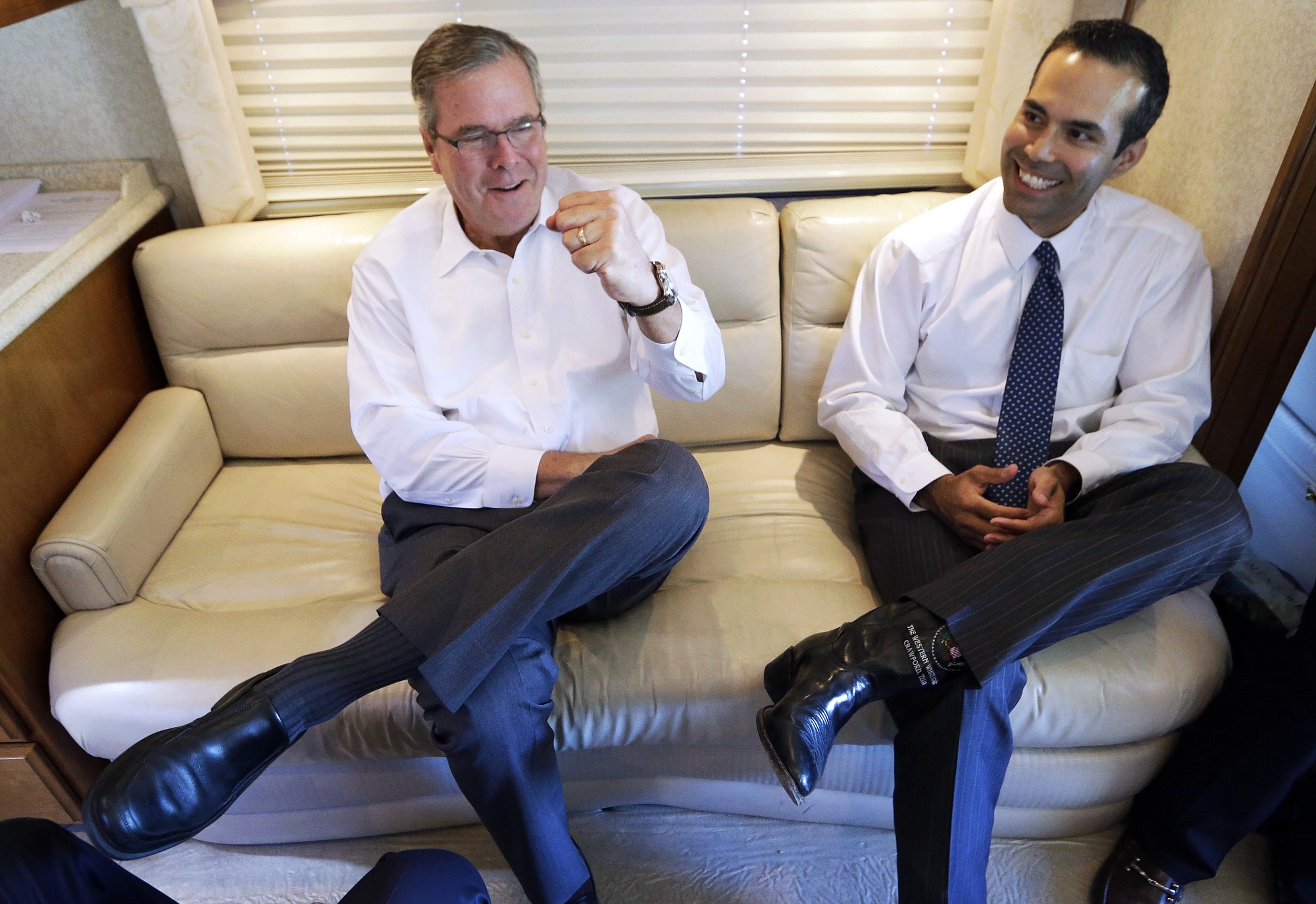 George P. Bush, right, smiles as his dad, former Florida Gov. Jeb Bush, gives a fist pump Oct.