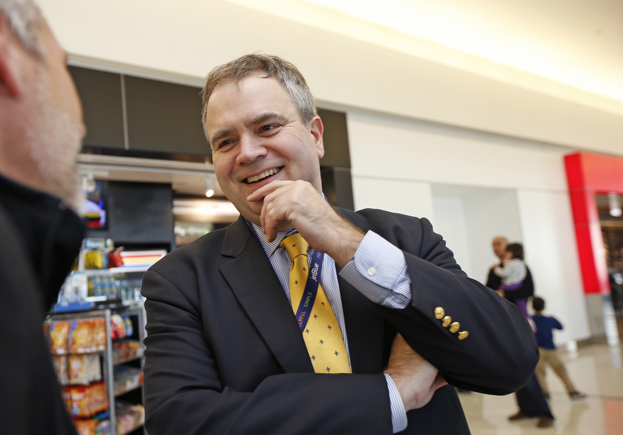 JetBlue's incoming CEO Robin Hayes talks to a departing airline passenger in the JetBlue terminal at John F.