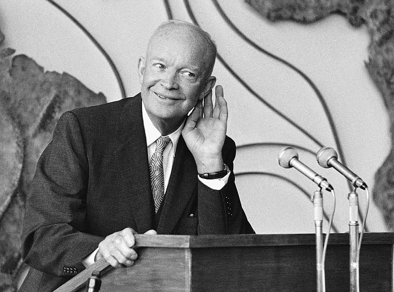 President Dwight D. Eisenhower cups his ear as he listens to a question from a newsman at an Aug. 27, 1959, news conference at the West German Foreign Ministry in Bonn, Germany.