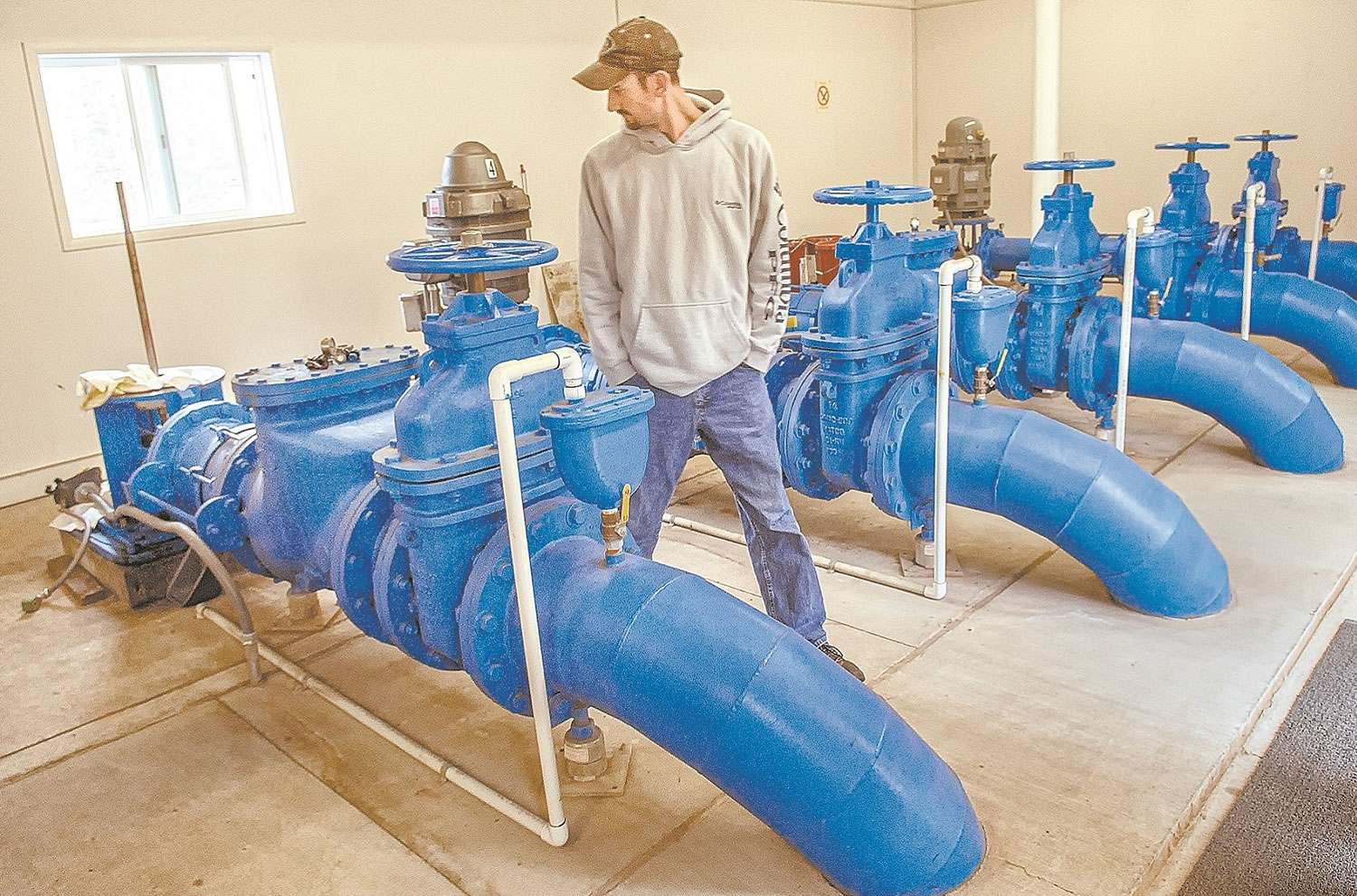 Sam Gibbons, manager of the Kalama Falls Hatchery, walks through the pump room where a problem led to the death of 200,000 fish last week.
