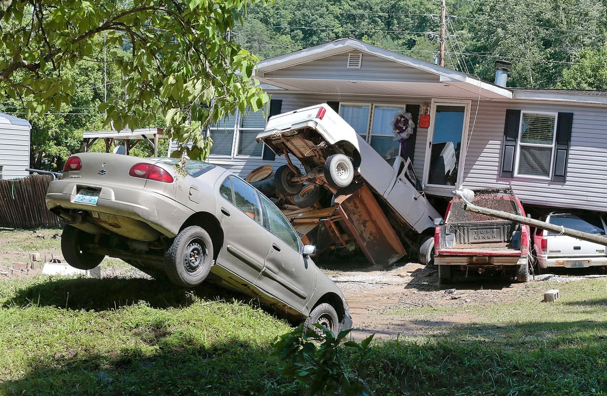 Cars were tossed around and houses moved from their foundations during flash flooding Tuesday in Flat Gap, Ky.