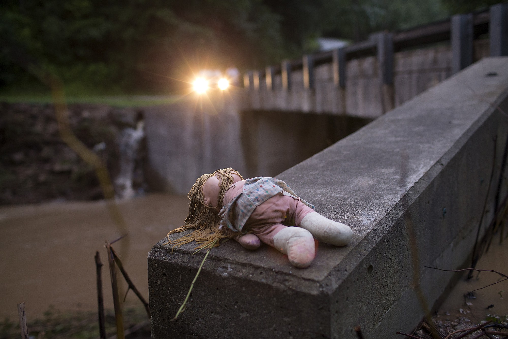 A doll rests a bridge after deadly flooding in Flat Gap, Ky., on Tuesday.