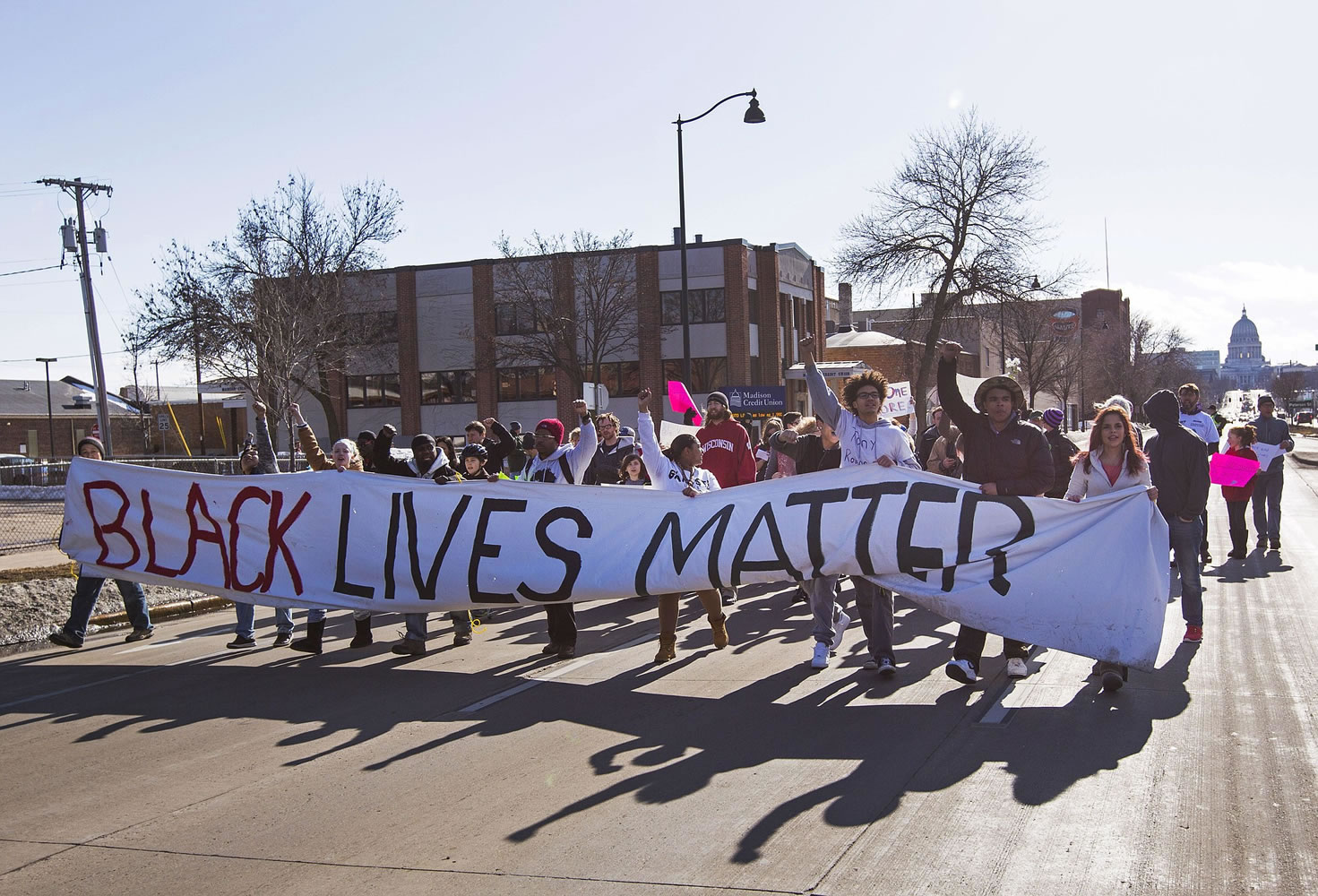 People march Sunday in Madison, Wis., following the shooting death of Tony Robinson.