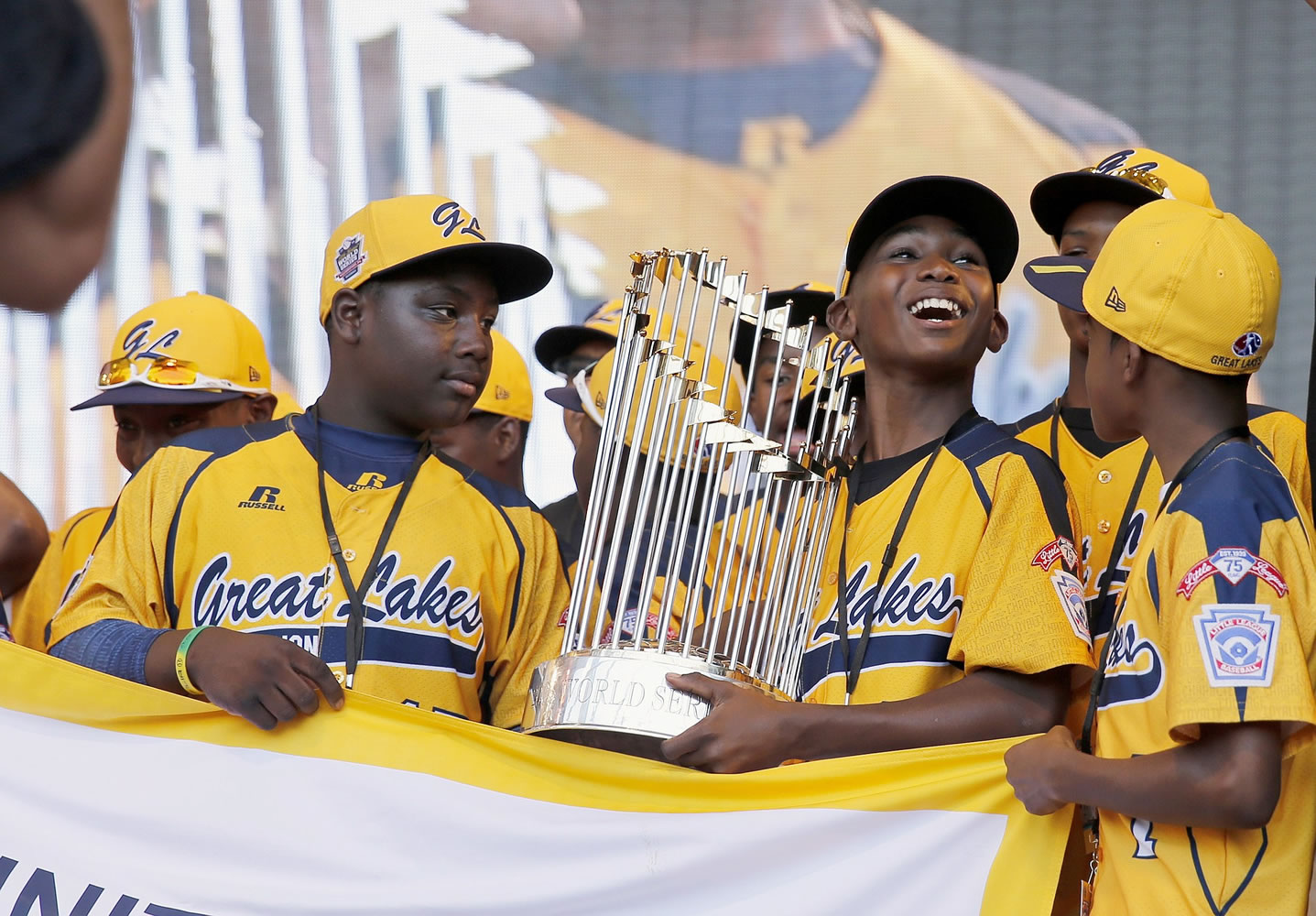 In this Aug. 27, 2014, file photo, members of the Jackie Robinson West Little League baseball team participate in a rally in Chicago celebrating the team's U.S. Little League Championship. Little League International has stripped Chicago's Jackie Robinson West team of its national title after finding the team falsified its boundary map. The league made the announcement Wednesday morning, Feb. 11, 2015, saying the Chicago team violated regulations by placing players on the team who didn?t qualify because they lived outside the team?s boundaries.