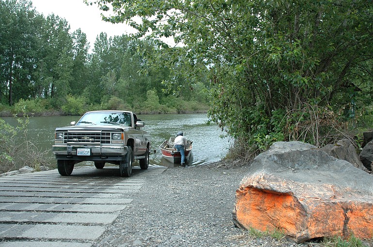 A fisherman loads his boat at the Langsdorf Landing ramp on Caterpillar Slough after a trip for summer chinook salmon.