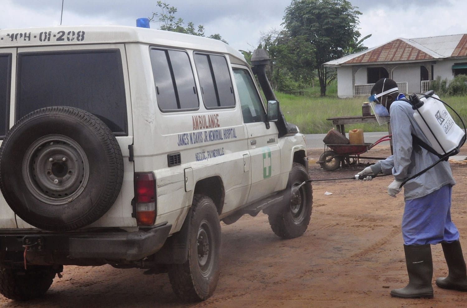 Ebola health workers spray disinfectant on an ambulance that was used to transport two people suspected of having the Ebola virus  on the outskirts of Monrovia, Liberia, on Wednesday.