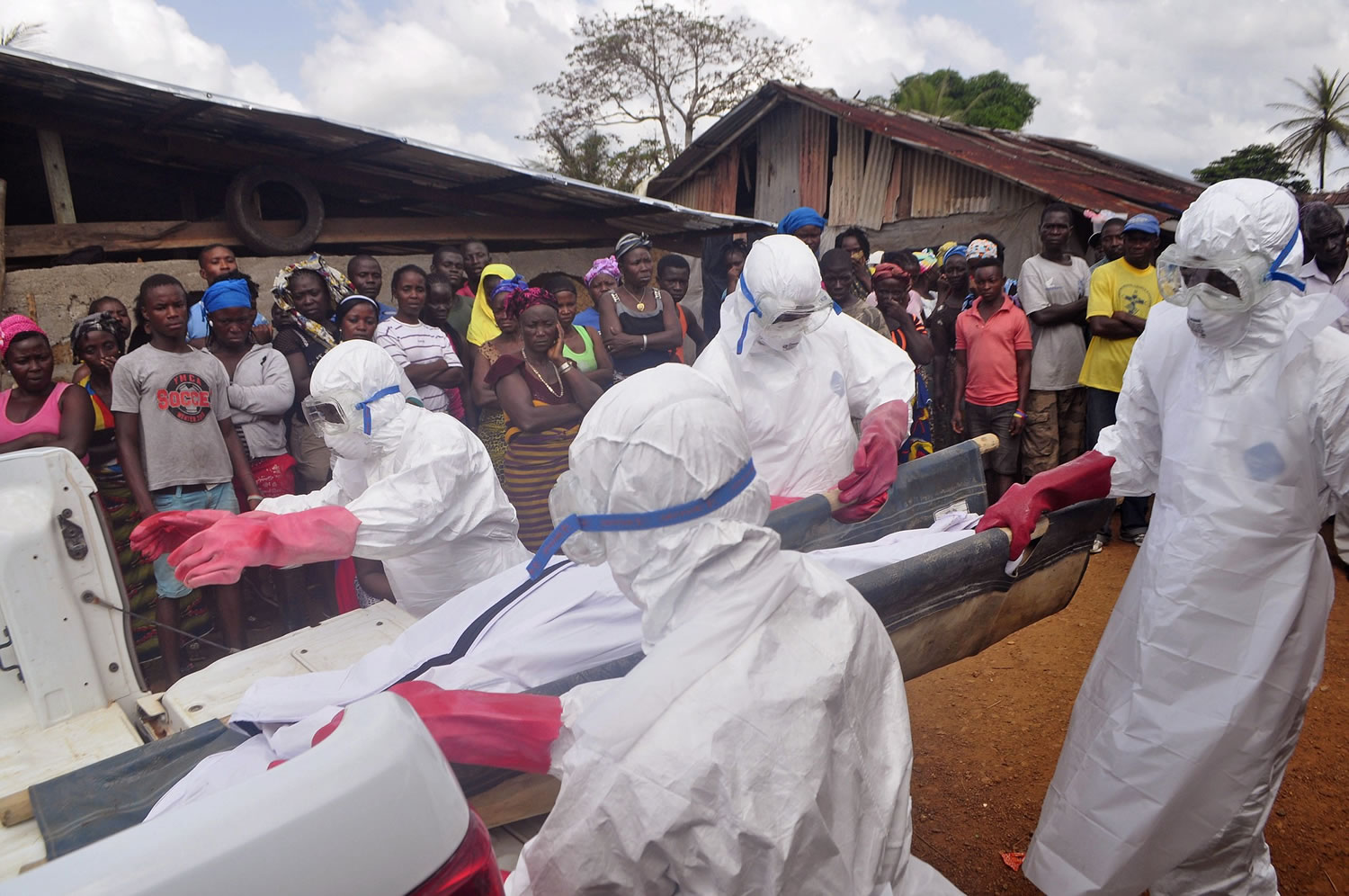 Ebola health care workers on Friday carry the body of a man suspected of dying from the Ebola virus in a small village Gbah on the outskirts of Monrovia, Liberia. A U.N. peacekeeper who contracted Ebola in Liberia will be flown to the Netherlands for treatment, a Dutch Health Ministry spokeswoman said Friday.