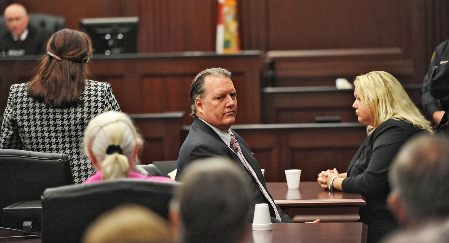 bob mack/Associated Press
Michael Dunn, center, looks back at his parents after the verdict in his retrial Wednesday in Jacksonville, Fla. A jury found Dunn guilty of first-degree murder.