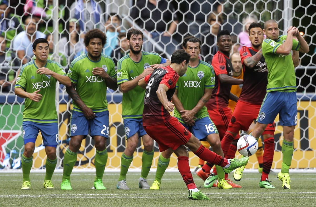 Portland Timbers' Diego Valeri's (8) free kick is blocked by the Seattle Sounders during added time at the end of the second half of an MLS soccer match, Sunday, Aug. 30, 2015, in Seattle. The Sounders beat the Timbers 2-1. (AP Photo/Ted S.