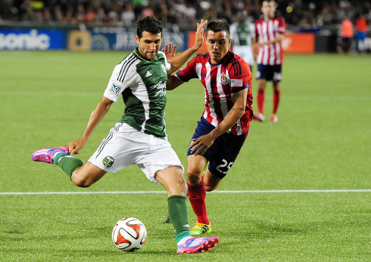 Portland Timbers midfielder Diego Valeri, left, puts a shot on goal as Chivas USA defender Donny Toia closes in during the second half Saturday, Aug.