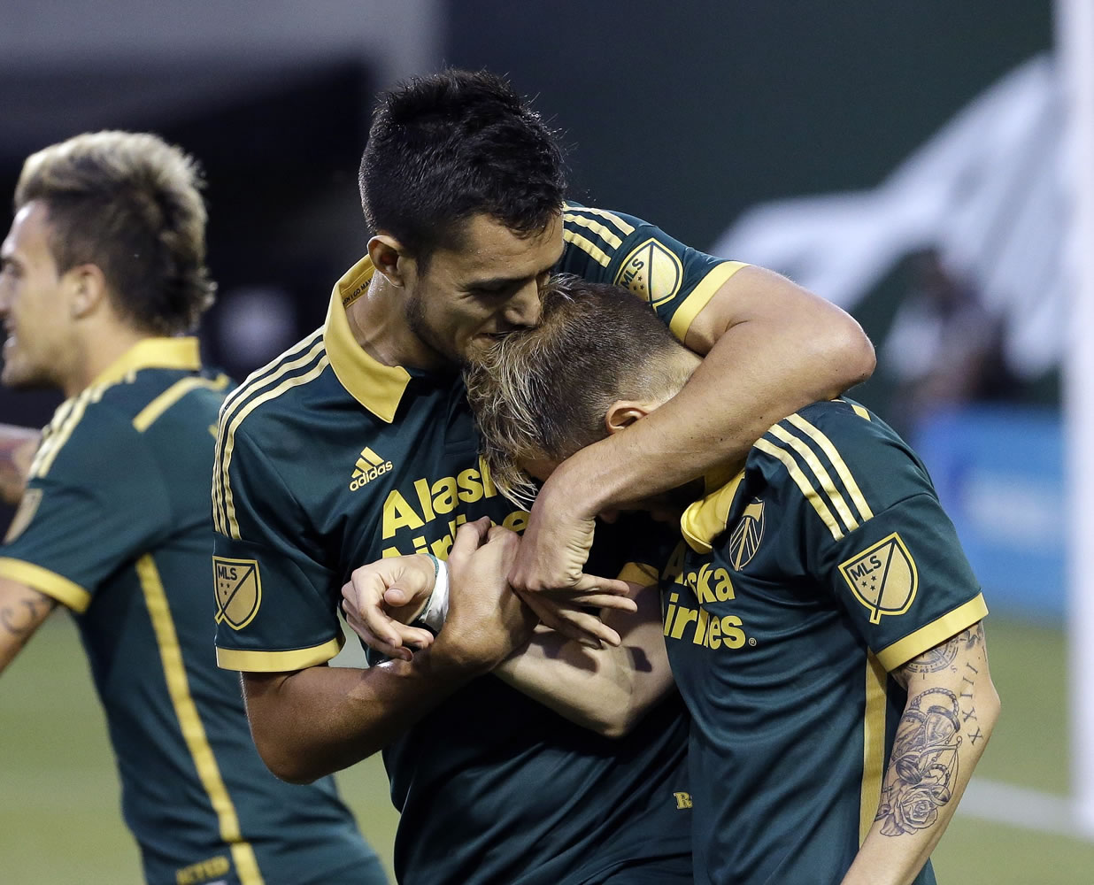 Portland Timbers forward Gaston Fernandez, right, is hugged by Norberto Paparatto after Fernandez scored on a penalty kick Saturday against the Houston Dynamo.