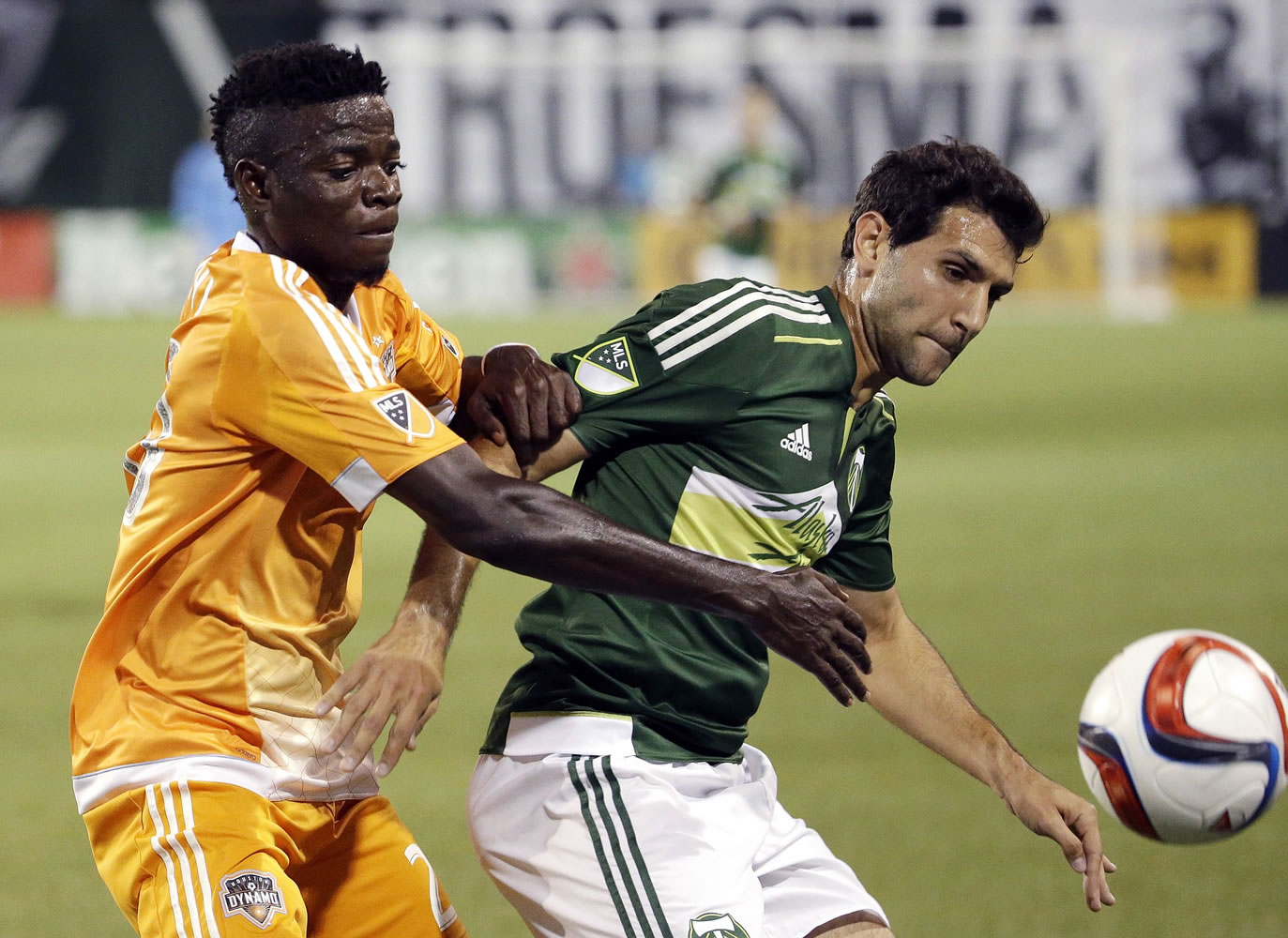 Portland Timbers midfielder Diego Valeri, right, battles Houston Dynamo midfielder Rasheed Olabiyi for possession during the first half of Friday's game at Providence Park.