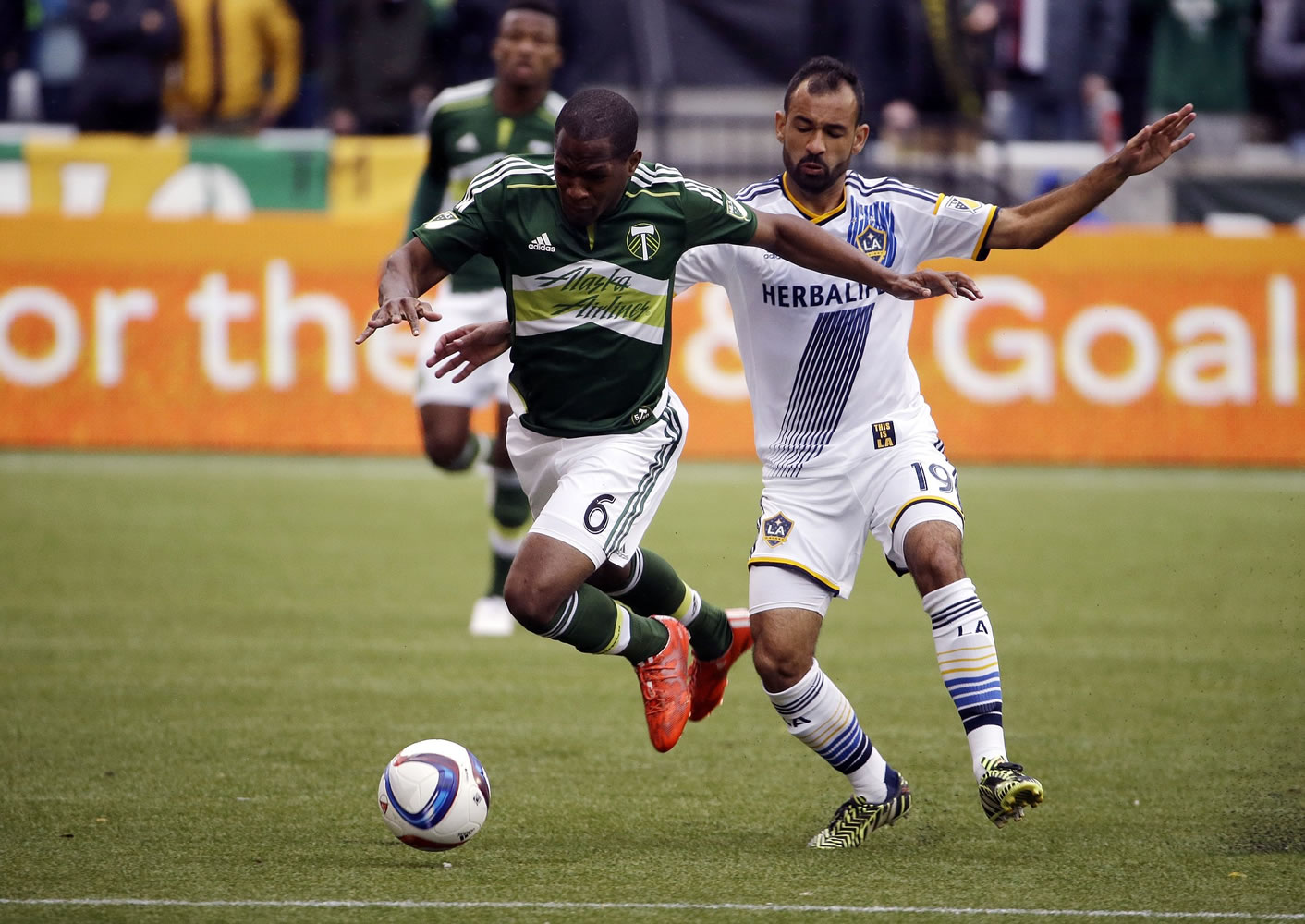 Portland Timbers forward Darlington Nagbe, left, chases down the ball against Los Angeles Galaxy midfielder Juninho during the first half of an MLS soccer game in Portland, Ore., Sunday, March 15, 2015.