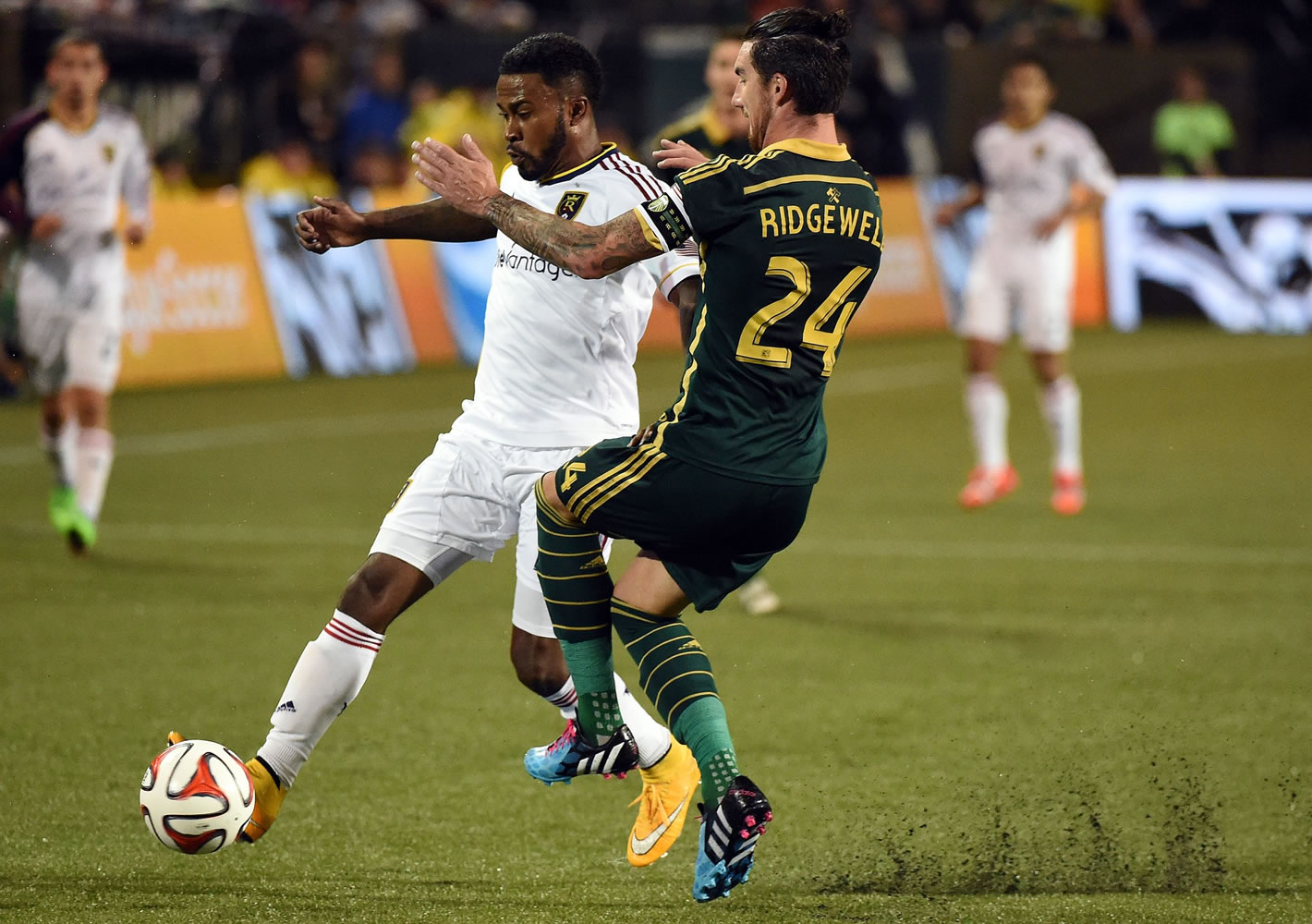 Real Salt Lake forward Robbie Findley,left, and Portland Timbers defender Liam Ridgewell (24) battle for a ball during the first half Friday, Oct. 17, 2014, in Portland.