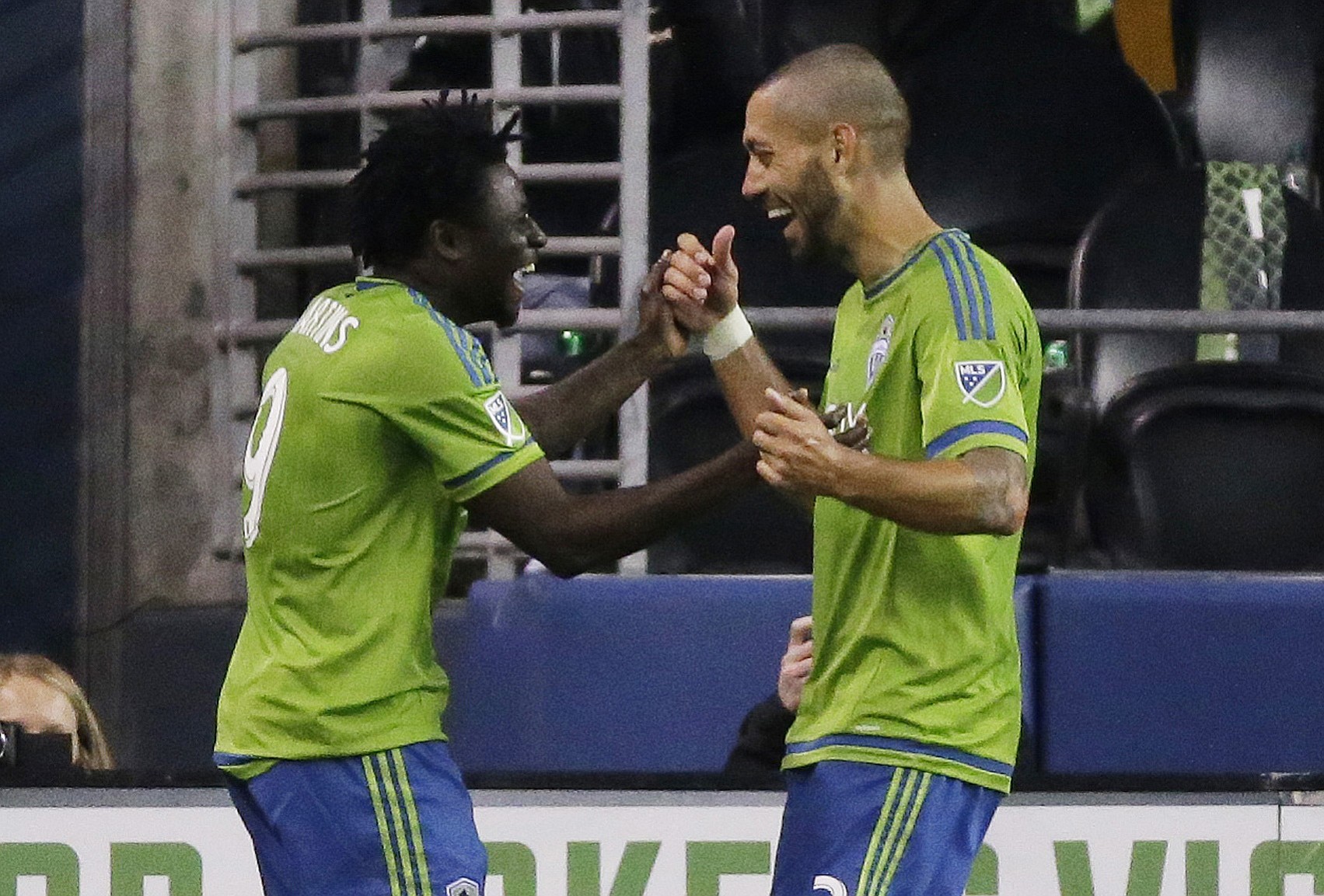 Seattle Sounders' Obafemi Martins, left is greeted by Clint Dempsey, right, after Martins scored a goal against the New England Revolution in the first half Sunday, March 8, 2015, in Seattle. Dempsey also scored in the first half of the match. (AP Photo/Ted S.